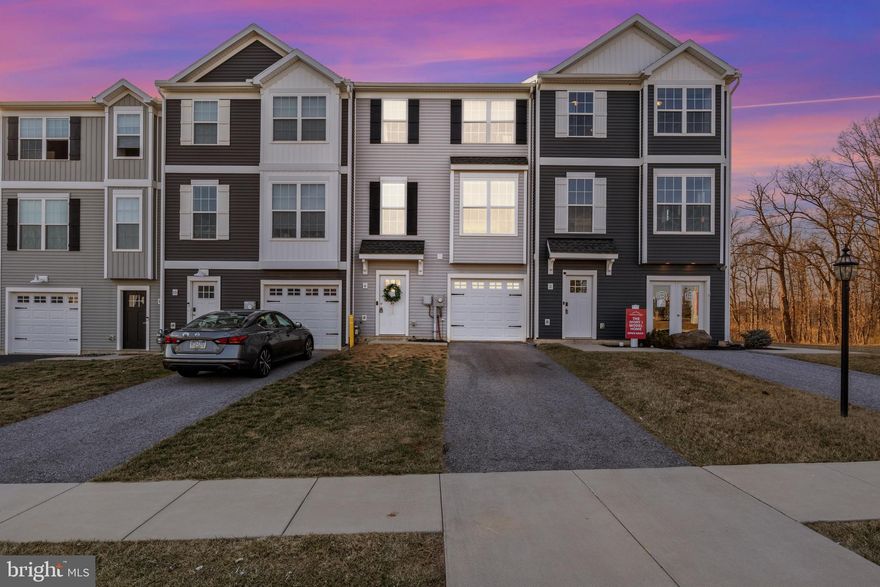 Buyer got cold feet! Back on market at no fault of its own! Stunning 3-Bedroom Townhouse in Dallastown School District – Immaculate & Move-In Ready! Welcome to this beautifully maintained three-bedroom, 2.5-bathroom townhouse, built in 2019 and located in Dallastown School District. From the moment you arrive, you’ll appreciate the care and attention that has kept this home in pristine condition. Step inside to discover a bright, open-concept main level featuring modern finishes and plenty of natural light. The spacious kitchen boasts stainless steel appliances, ample cabinetry, and a center island, perfect for meal prep and entertaining. Just off the kitchen, sliding glass doors lead to a private deck, offering a perfect space to relax or enjoy outdoor dining with an exceptional view of the sunset each evening. Upstairs, the primary suite is a true retreat, complete with a walk-in closet and an en-suite bathroom. Two additional bedrooms provide flexibility for family, guests, or a home office. A second full bath and conveniently located laundry area complete the upper level. The attached garage offers secure parking and additional storage, while the lower level features a welcoming entryway, access to the garage, and a cozy family room with outdoor access. This home is truly move-in ready—immaculate, well-kept, and designed for modern living. Conveniently located near shopping, dining, and major commuter routes, this is an opportunity you won’t want to miss! Schedule your showing today!