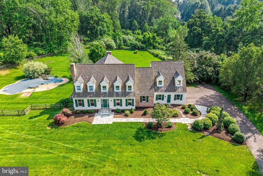 Tucked along one of the most scenic roads in Solebury, this character-filled estate offers timeless elegance, thoughtful updates, and peaceful outdoor living—just minutes from downtown New Hope.
Set behind a gated entrance on 3.43 acres, the home makes a memorable first impression with its stone pillars and long driveway. Inside, you’re welcomed by a brick entryway that sets the tone for the home's character. Hardwood floors flow throughout the main level, where two distinct living rooms—each with a wood-burning fireplace—provide inviting spaces for both everyday living and entertaining. A formal dining room offers a dedicated space for gatherings, while a private office, updated powder room, full laundry room, and mudroom add daily functionality.
The kitchen is equipped with a propane Viking stove, center island with prep sink, wet bar, and custom cabinetry. A bright breakfast area opens to a deck overlooking the pool and backyard—ideal for morning coffee, casual meals, or outdoor hosting.
Upstairs, the primary suite includes two walk-in closets, a renovated en-suite bath with a freestanding tub and private water closet, and a private deck with views of the yard. Two additional bedrooms share a Jack and Jill bath that also connects to the spacious bonus room above the garage—perfect for guests, hobbies, or play. A third upstairs bedroom and a separate staircase to the bonus room offer additional flexibility.
The walk-out basement remains unfinished, offering space for future expansion. Outside, the property includes a pool, hot tub, and water feature, all set against a backdrop of mature trees.
Located in the New Hope-Solebury School District and just minutes from the area’s best shopping, dining, and river towns, this home blends classic Bucks County appeal with generous space and a sought-after location.