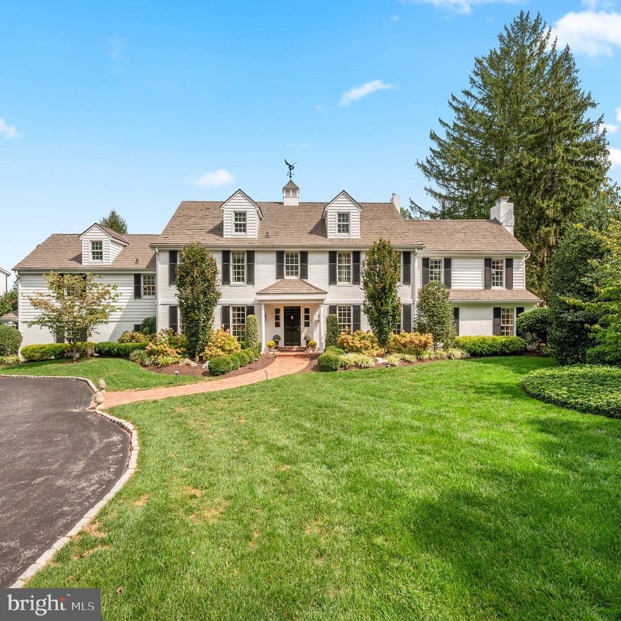 The curb appeal is just the beginning of your love affair with this stunning property! This spectacular three-story expanded Colonial sits on a private, beautifully landscaped 1.4-acre lot on a quiet Northside Villanova cul-de-sac. Warm, yet sophisticated, this "Forever house” is a rare opportunity, set on one of the most desirable lanes in Villanova.
Thoughtfully renovated from top to bottom, the home blends timeless elegance with modern luxury, offering space for both grand entertaining and everyday living. From the gourmet chef’s kitchen to a custom pub room, a wine cellar, and lush grounds with pool and spa—every space has been designed with comfort and style in mind.
Enter the property through stone pillars on either side of the circular drive. The first floor welcomes you with a gracious foyer featuring charming millwork and hand-pegged wood floors that flow into the fabulous eat-in kitchen, showcasing Halkett custom cabinetry, double-thick marble countertops, custom mosaic backsplash, 6-burner Wolf range with grill, separate Thermador refrigerator and freezer, wet bar with beverage frig, and a unique coffee bar pantry. The adjoining dining room is perfect for large gatherings, while the oversized family room connects to the elegant step-down living room with gas fireplace, crown moldings, French doors, and serene yard views.
Just off the kitchen is a mudroom with built-ins and garage access. A breezeway/sunroom leads to the custom pub room, paneled with reclaimed wood from a Chicago speakeasy, complete with electric fireplace, powder room, and French doors to the fire pit area and backyard—an entertainer’s dream. This versatile space could also function as a private office with its own entrance.
The finished lower level offers a 1,500-bottle temperature-controlled wine cellar, gym, laundry, and storage.
The second floor showcases the luxurious primary suite including a sitting area, gas fireplace, and two walk-in closets with brand-new custom cabinetry. The marble ensuite bath boasts heated floors, imported fixtures, television, custom cabinetry with charging station, and a private WC. Four additional bedrooms and four baths (three ensuite) complete this level, including a full in-law/guest suite featuring a kitchenette, sitting room, laundry, and spacious bedroom with full bath.
The third floor provides flexible living space with a great room, office, and an additional full bath. A game room offers abundant cabinet storage and access to a large walk-in attic storage.
Outdoor living shines with a large bluestone patio and awning-covered sitting and dining area overlooking the pool, spa with waterfall, and lush landscaping with hydrangeas, mature trees, and plenty of flat yard space for play, pets, or relaxation.
Located in the award-winning Lower Merion School District and close to many private schools, universities, country clubs, shopping, dining, and major highways to Philadelphia, New York, and beyond—this exceptional home offers convenience, luxury, and Main Line living at its best. 
Showings start Thursday the 18th. Schedule your private tour today!