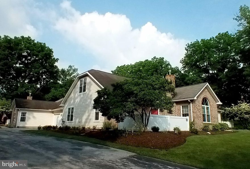 Here's the one you've been waiting for! Located at the far end of the community, 204 Mill Bridge is one of the two-bedroom, two-bath, 2-car garage units in the quiet corner with beautiful natural views.  Updated by it current owner is 2012, this unit is ready for you to make it home!  Beautifully updated kitchen with ample cabinet space and a small island, it opens to the dining space and living room  with fireplace that is filled with early-morning light through the 2 story window. The first floor powder room has been redone with grab bars installed.  The Master bath was also redone and boasts an oversized, roll-in tiled shower with grab bars and a handheld shower accessory.  The upstairs full bath has also been redone so that guests have the option for a bath or a shower.   Convenient pantry/laundry area from the garage makes putting away groceries a breeze!  Outside, the patio is a lovely space to have morning coffee or afternoon tea, and to tend to the flower garden. This unit is walking distance to the shopping center and has beautiful views from the windows - no looking at other units!