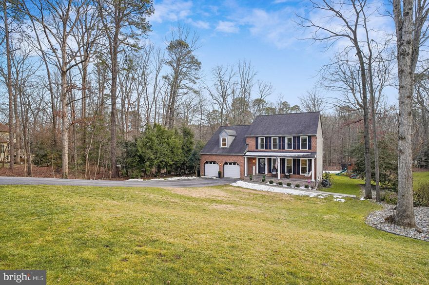 Completely renovated Colonial with custom finishes throughout in the beautiful community of Woodbridge Forest. This updated home sits on a rare, oversized lot in the heart of Severna Park and has been thoughtfully renovated between 2020 and 2026. The welcoming front porch, complete with a built-in swing, is the perfect spot to relax and unwind. Inside, you’ll find a wide entryway with custom built-in cubbies that create an ideal mudroom setup. Brazilian oak hardwood floors run throughout the main and upper levels, adding warmth and character. The main level offers a great balance of traditional spaces and open flow. There’s a formal dining room, a sunken living room with a gas fireplace, and a convenient half bath. The kitchen truly anchors the home. Designed with entertaining in mind, it features a six-burner gas range with griddle and dual ovens, a large quartz waterfall island with matching backsplash, and a butler’s pantry with butcher block counters and floating shelves. The accordion pass-through window opens directly to the covered porch and includes a bar-top on the other side, making indoor-outdoor hosting seamless. All kitchen appliances were replaced in 2025. Just off the kitchen, the vaulted covered porch offers low-maintenance Trex decking, an electric fireplace, and plenty of space for dining and lounging year-round. The adjacent deck provides even more room to gather and features dual staircases leading to the backyard. Upstairs, you’ll find four spacious bedrooms and three full baths. The primary suite includes a large walk-in closet and an oversized private bath. The finished lower level adds flexible living space with a recreation area, a full bedroom and bath, and a generous utility and storage room.  The backyard is a standout feature. Large wooded lots like this are hard to find in Severna Park. With added privacy and space to enjoy the outdoors, including a custom-built dirt bike trail tucked into the wooded area — this property offers something truly unique. Extensively updated and well maintained, this move-in-ready home offers space, function, and thoughtful design throughout. Don’t miss your opportunity to see it in person.