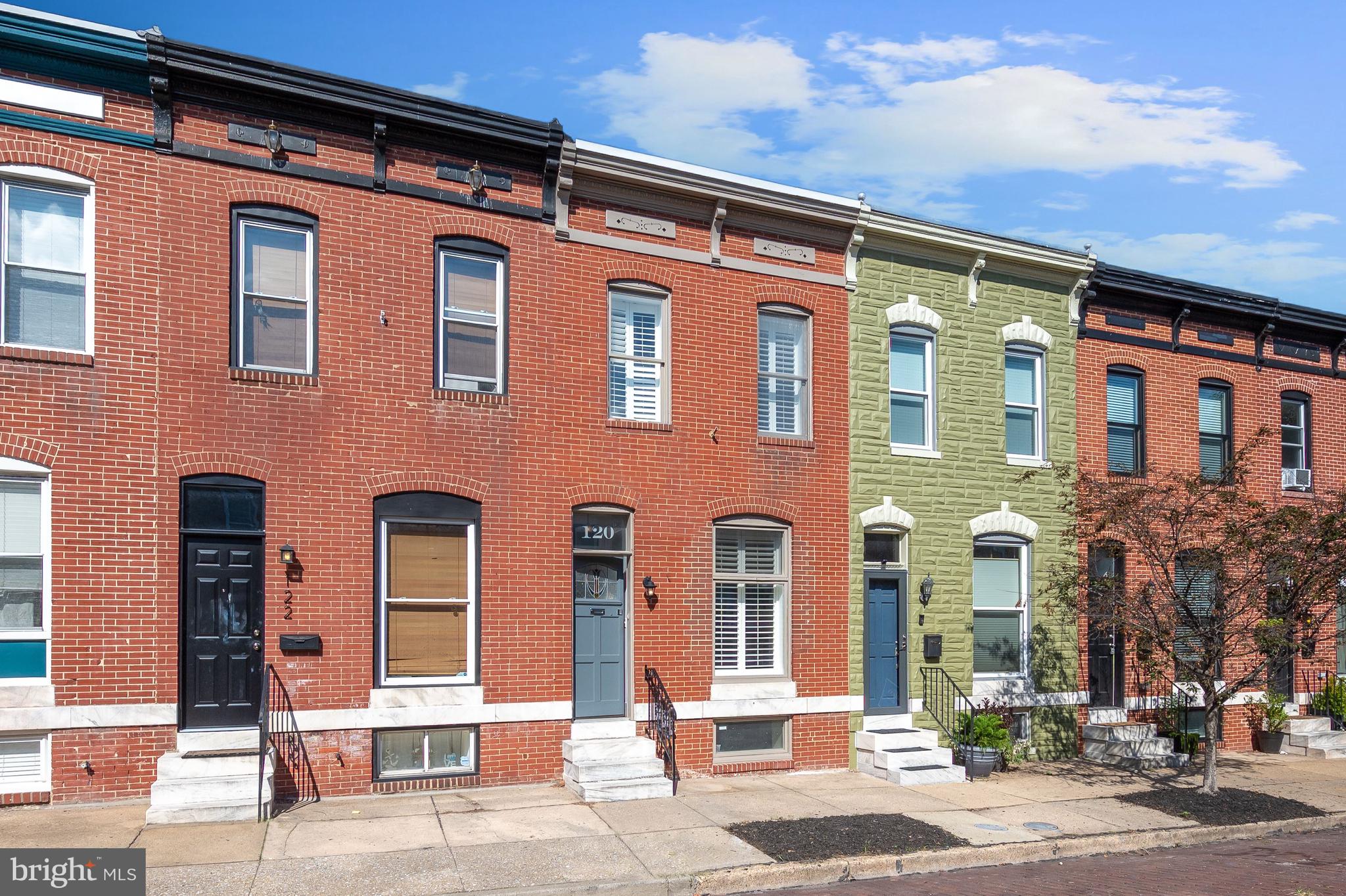 Prepare to fall in love with this charming two bedroom rowhome in Highlandtown close to Patterson Park and the best that Baltimore city living has to offer! Showcasing remarkable hardwood floors, sun-drenched windows, a freshly painted neutral color palette, open floor plan, plantation shutters, and delightful details throughout. The spacious living room and dining room are large enough for any size gathering. Make your favorite meals in the updated kitchen fully equipped with stainless steel appliances, tile backsplash, display cabinets, and ample counter and storage space. Ascend upstairs where the hallway is adorned with a bright skylight and built-in shelves for displaying your mementos. The primary bedroom features a massive walk-in closet and the upper level full bathroom has a tile tub-shower. The full basement awaits your final touches and was waterproofed with a sump pump in 2019. Other recent updates include a fantastic parking pad, water heater gas flue in 2018, new roof membrane and openings were sealed in 2019, exterior painted in 2019 and the sewer line was inspected in 2018.