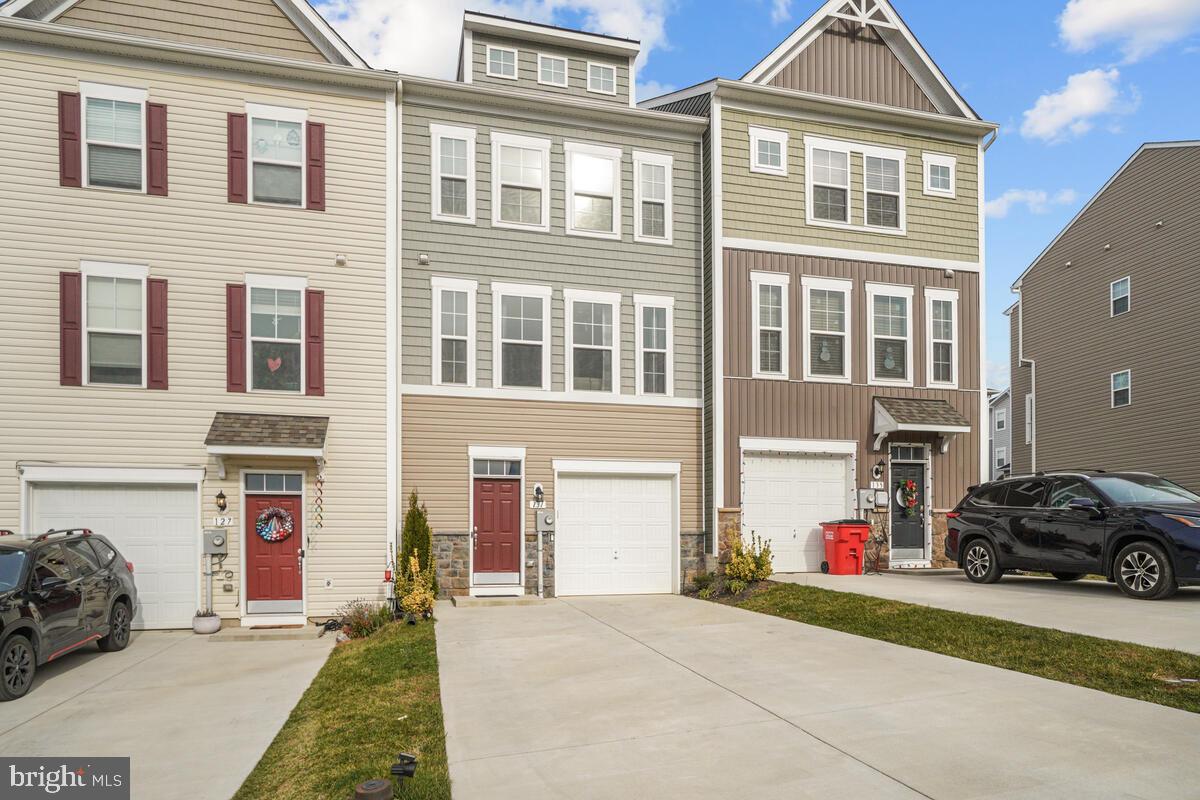 Welcome to Overlook at Riverside, a beautiful community located in Falling Waters, WV! This better-than-new garage townhome offers all the benefits of new construction without the wait. Step inside and you'll find a fresh, neutral color palette and tons of natural light throughout. The entry level features a spacious rec room, full bath, and walk out to the backyard. Head upstairs to the main living area, and the gleaming hardwood floors, and warm kitchen cabinetry await. The kitchen also offers stainless steel appliances, and plenty of table space for entertaining. The upper level of this home boasts 3 bedrooms, including the primary suite with a tiled shower and soaking tub. The additional bedrooms also offer ample space and share a hall bath on this level. On top of all these wonderful home features, you will also enjoy the community amenities such as basketball courts, picnic areas & playgrounds. Don’t miss out on this incredible opportunity - schedule a tour today!