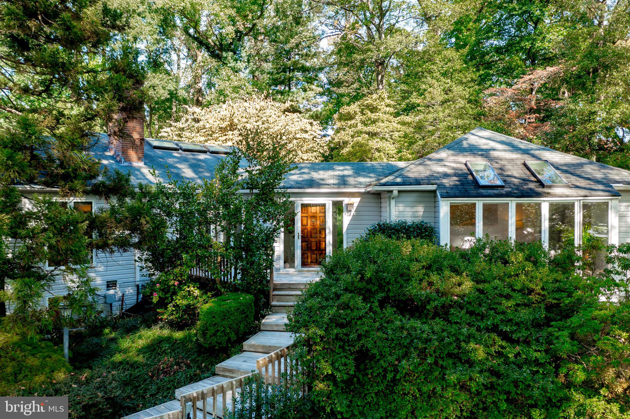 Extraordinary opportunity on beautiful Gibson Island! Spacious home with separate guest quarters is perfect for gatherings large and small. Airy and light filled, the living room with wood burning fireplace flows to the dining room. The generous open kitchen /family room connects seamlessly with the private patio for lounging and outdoor dining and is sure to become the favorite spot for hosting friends and welcoming family. The house's clever design included separate quarters so that there is privacy and lots of comfortable space for everyone. The updated primary suite on the main level offers water views and is easily accessed from the carport. Other outstanding features include a two car garage, excellent storage and even a greenhouse, all of which are joined by a covered walkway. This residence offers plenty of tranquil places to enjoy the Japanese garden which surrounds the property. Truly a must see to appreciate!