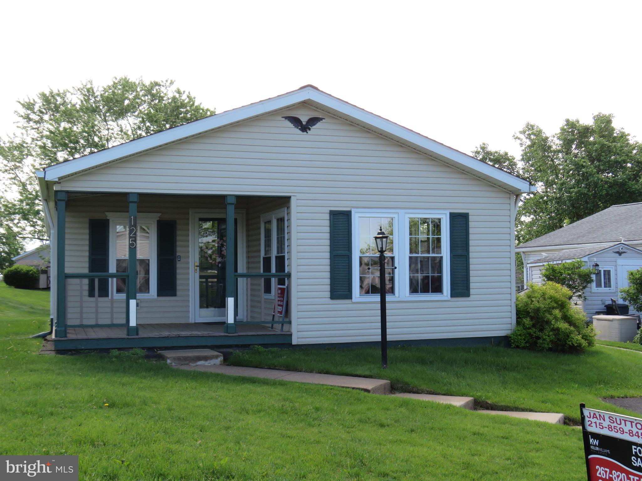 This sweet home is ready for you to move right in. Located in the active adult community of Buckingham Springs. Enter the home through the large patio into the living room with lofted ceilings that opens to a dining room with laminate floors through out. This Warrington Model has a large bright eat in kitchen with plenty of cabinets. In the hall is the Laundry room with cabinets, heater closet and a door that opens to a side patio that is fenced and has a retractable awning. The Primary bedroom is large with walk in closet, second closet and opens to the double door primary bathroom with soaking tub, shower stall and vanity. The second bathroom sits next door to bedroom 2 with large closet. New Roof and 6 new windows and flooring in 2015, Washer 2023 and Dryer 2018, toilets 2021. This home is priced perfectly for you to come in and make this place your own. The land lease includes sewer, trash, clubhouse and pool.