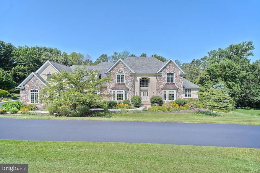 Stunning home in desirable Saddle Ridge offers quality, charm & character in a serene setting. An impressive 2 story opens to a grand family room with floor to ceiling stone fireplace & views of back yard oasis from multiple windows. Splendid gourment kitchen offers custom cabinetry and tile work, granite counters, large center island & back deck access. Dramatic try ceiling in the dining room is lovely while the living room, conservator and study provide comfortable family & entertaining spaces. Enjoy the convenience of a 1st floor bedroom & full bath, laundry, powder rm & back stairway. Vast master suite on second level presents a sitting rm with gas fireplace, tile & glass shower, spa tub & huge walk-in closet. Three more bedrooms & 2 full baths comprise this level. Beautifully finished lower level has sitting & game rms. wet bar, full bath & bedroom and open to stone patios, fire pit 7 perennial gardens offering serenity and privacy. Just minutes from Rt78, SVCC & shopping.