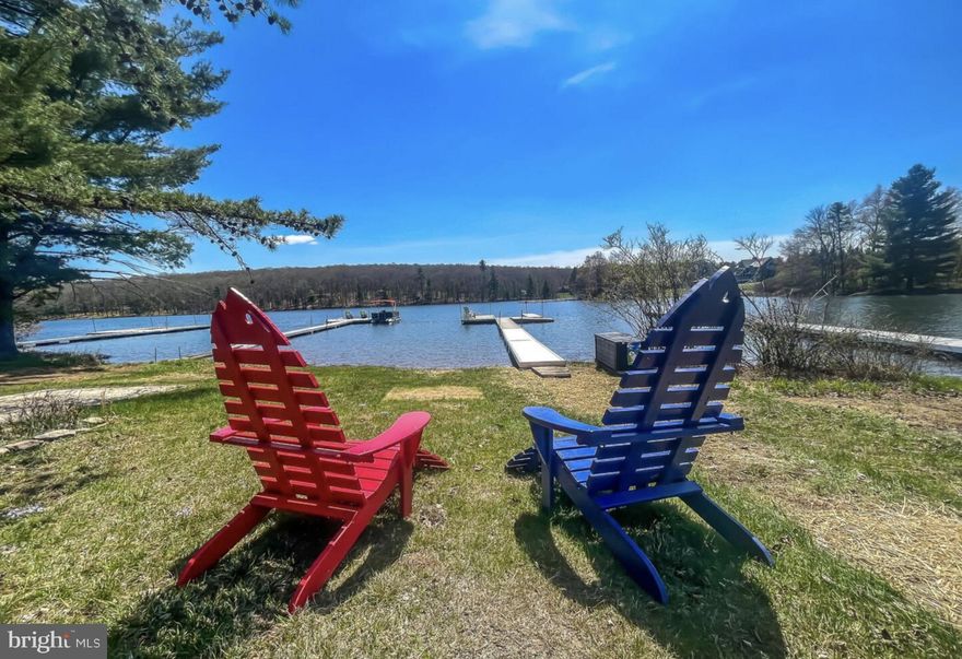 "In the Groove" is a newly constructed, high-end lakefront home offering 5 bedrooms, 4.5 bathrooms, and over 3,300 square feet of finished living space on a level lakefront lot in a quiet no-wake cove of Deep Creek Lake. This property features 85 ft of lakefront, a Type A dock with a jet ski port included, no HOA, and a high-grade automatic fire sprinkler system with a dedicated control panel for enhanced safety and code compliance. Inside, you’ll find premium finishes throughout, including custom-built cabinetry, Delta fixtures, Andersen windows, and an oversized custom Andersen slider framing those beautiful lake views. The kitchen is equipped with Viking appliances, dual ovens, a wine fridge, and a large center island. The main level showcases vaulted knotty-pine ceilings, floor-to-ceiling windows, a gas fireplace, and premium or custom-built furniture. Upstairs features two spacious ensuite bedrooms, a dedicated workspace, and a loft area with views overlooking the lake. The lower level includes two additional bedrooms that share a large full bath with hall access, plus a rec room with gas fireplace, wet bar, shuffleboard, and foosball. Outdoor living is elevated with a wrap-around deck, lower patio with hot tub, and lakeside firepit. Located just minutes from Wisp Resort, Arrowhead Market, and local dining, this is a rare opportunity to own a luxury lakefront home in one of Deep Creek’s most desirable settings. Proven rental history will be provided upon request!