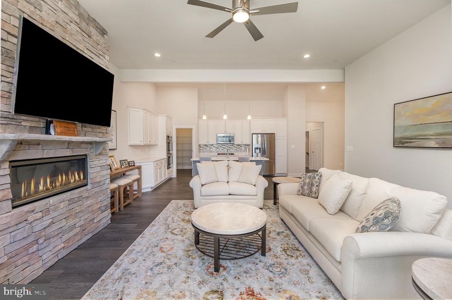 New construction without the wait! Welcome to The Macbeth I of Aumar Village. This spacious villa was built in 2022 & has just over 3,300 finished SF of luxury living. The gourmet kitchen showcases barrel ceilings, 42'' white cabinets, quartz countertops, walk-in pantry and gleaming stainless-steel appliances including a double wall oven, gas cooktop, built-in microwave and breakfast island. Separate dining area with barrel ceiling. Great room with recess lighting, floor to ceiling stone gas fireplace, large glass slider with remote blinds and access to the covered composite deck. This 3 bedroom, 3 bath home includes a primary suite on the main level with tray ceiling, massive walk-in closet & a gorgeous en-suite bathroom with dual vanity. First floor separate laundry room with quartz counters. Large walkout finished basement with another bedroom and full bath. Easily convert the unfinished space to another room. Luxury vinyl plank and remote blinds throughout main level. 2 car front load garage plus private driveway make for easy parking. Great location with easy access to 95, local shopping and dining. This one has it all!