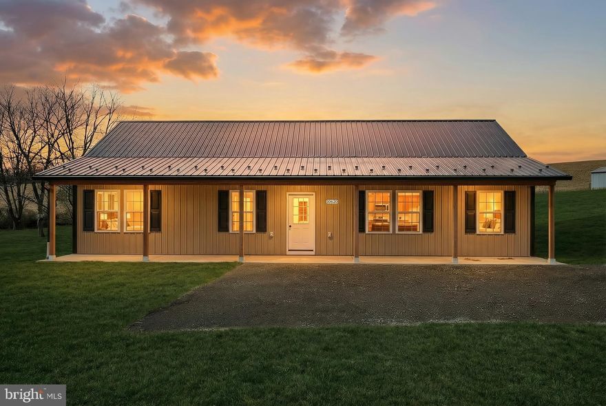 Welcome to 10620 Enfield Rd. a thoughtfully designed barndominium-style home by National Home Services, set on a private and peaceful 1+ acre lot. This property offers a rare combination of modern construction, efficient single-level living, and a quiet country setting—ideal for buyers looking for low-maintenance ownership without sacrificing space or comfort.

As you arrive, the home’s clean exterior lines and durable metal siding and roofing immediately stand out. A full-length front porch with recessed lighting creates inviting curb appeal and offers the perfect spot to relax and take in the surrounding privacy. Step inside to discover a bright, open-concept layout designed to maximize both everyday living and entertaining.

The interior features three generously sized bedrooms and two full bathrooms, all thoughtfully arranged on one level. The main living space flows seamlessly into the kitchen, which is finished with granite countertops, stainless steel appliances, soft-close cabinetry, and a large center island that anchors the room and provides plenty of prep and gathering space. Natural light fills the home, enhancing the open feel and making each space warm and welcoming.

The owner’s suite is a comfortable retreat, complete with a walk-in closet and a private bathroom finished with quality materials and timeless design. The additional bedrooms offer flexibility for guests, a home office, or hobbies, while the second full bathroom is conveniently located for both residents and visitors.

Outside, the property truly shines with over an acre of usable land offering privacy and flexibility. 

Built with an all-electric, single-utility layout, this home is well-suited for energy-conscious buyers and offers potential for future solar integration. With its efficient design, durable materials, and peaceful setting, 10620 Enfield Rd. delivers a lifestyle that is both practical and flexible—ready to meet your needs today while offering room to grow tomorrow.