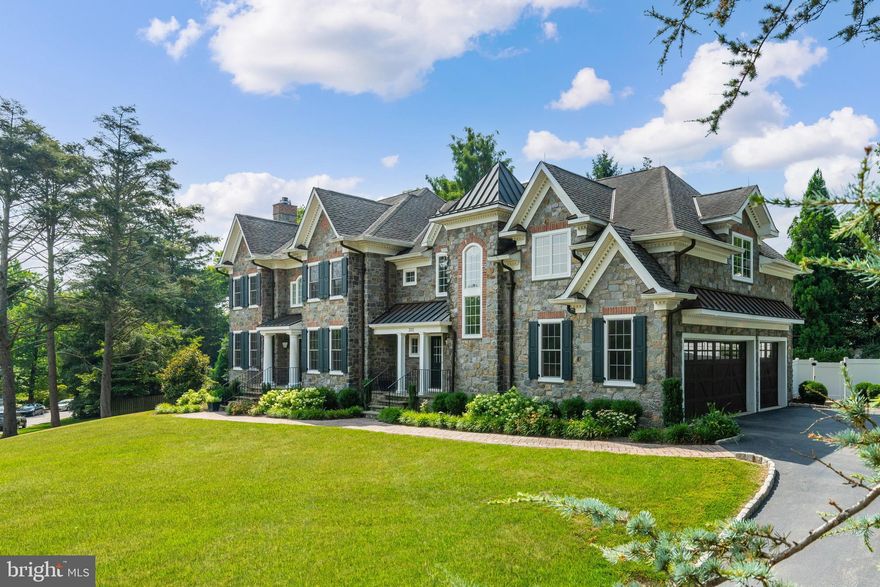 The Main Line home you’ve been waiting for has arrived in a gorgeous section of Bryn Mawr in the award winning Lower Merion township.  This stunning residence, designed by Peter Batchelor and built by Farley Homes, is situated on a quiet, mature wooded street, just steps from Harriton High School, the town of Bryn Mawr, Villanova University, Ashbridge Park, and more. This beautiful stone colonial home was crafted for comfortable living and elegant entertaining. As you approach 333 Greenbank, you’ll immediately appreciate the curb appeal and grandeur of this suburban palace, complete with a beautiful driveway featuring Belgian block leading to an oversized three-car garage with stylish wooden doors. Entering the main foyer, you’ll be wowed by the size and scale of the rooms and the airy floor plan. The first floor features a large formal living room with a gas fireplace and custom moldings, a gracious center staircase, and a large formal dining room with exquisite moldings. There’s also a home office/den with its own powder room, a great room with a wet bar, wine rack, and gas fireplace that flows seamlessly into the gorgeous gourmet kitchen and breakfast room overlooking the outdoor pool and yard. This floor is perfect for entertaining and large gatherings. Just off the kitchen, you’ll find a mudroom with its own powder room, storage, and back staircase leading up to the guest suite and main upper floor hallway. The upper floor boasts 5 large bedrooms and 4 full bathrooms, including a Jack and Jill bathroom, along with a conveniently located laundry room.  At one end of the main hallway, you’ll find a grand master suite with two walk-in closets and a large primary bathroom featuring a glass stall shower and a large jetted tub. On the opposite wing of the house is a spacious guest or nanny suite with a large spa-like bathroom. The lower level offers a huge finished basement with an exercise area, full bathroom, wet bar, media game room, and additional custom closets. Last but certainly not least, you’ll enjoy entertaining in your inground pool in the bucolic backyard. Other notable features include recessed lighting throughout, a sound system, central vac, a terrace overlooking the backyard on the first floor, a fenced in back yard, and multiple entrances to the home.  This standout property has it all, so dont hesitate and schedule your showings today! (Some photos have been virtually staged)