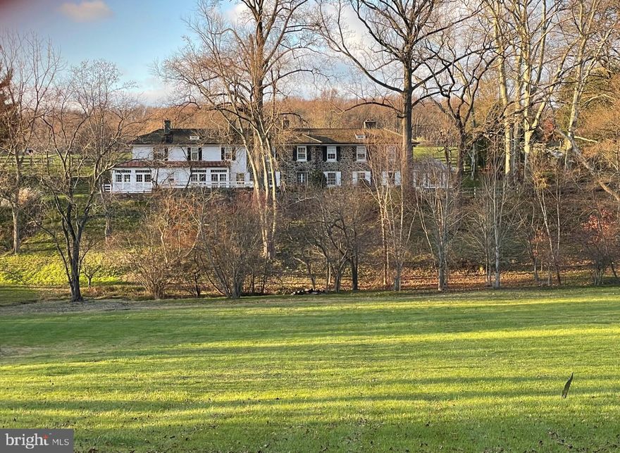 Welcome to 2415 White Horse Road, a beautifully restored stone farmhouse previously known as Pepper Farm,  nestled in the magnificent countryside of Radnor Hunt. Just under 8 acres, this conserved property offers tranquil views and breathtaking vistas while being within top rated Tredyffrin-Easttown schools.
Exquisite details abound in this home, including original hardwood flooring, deep windowsills, multiple fireplaces, original built-ins, and french doors that accent the rear of the home. The main level offers a massive family room with fireplace, built-in bookcase and hidden wet bar, while the attached conservatory with antique brick flooring has radiant floor heating and a concrete bar sink- the perfect space to unwind after a long day. The formal dining room with fireplace and built-in cabinetry is great for all your parties and get togethers and feeds into the magnificent kitchen with custom inset cabinetry, stainless steel appliances, and attached breakfast room with built-in cabinetry, desk and french doors exiting to the expansive patio overlooking the magnificent grounds. Finishing the main level is the den with wall to ceiling bookcases and additional french doors to patio, powder room, and mudroom with laundry area and back staircase.
The second level offers an amazing primary suite with two walk-in closets, fireplace, and newly updated bathroom with dual vanities and oversized shower. Two spacious bedrooms share a bathroom with tub/shower combo while the fourth bedroom with private bathroom can be accessed by the rear staircase.
The finished lower level offers a private office, full bathroom, tons of additional living space, and exterior door that exits to pool area. The beautiful grounds are accented with stone terraces, a lovely pool, fenced pasture, and a 4-car detached garage. This property offers country living at its best, yet is convenient to the shopping and dining options of Wayne and Bryn Mawr, close to major roadways for an easy commute to Philadelphia and Wilmington and minutes to some of the best private academies in the country. Call today to see this one-of-a-kind property- it is not to be missed!
*new cedar roof being installed soon on this home*