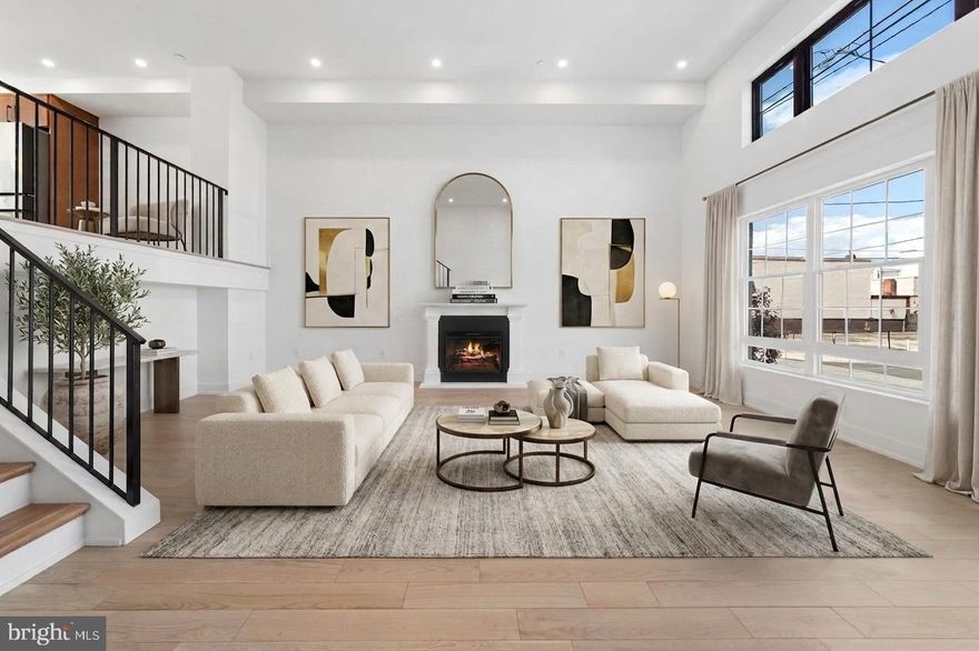 Set on a rare 20-foot-wide footprint with an expansive 20x100 lot, this newly completed residence offers a level of scale and presence seldom found in city living. Located along a picturesque, tree-lined street in Port Richmond, just moments from the energy of Fishtown and iconic Tacconelli's Pizzeria, this home is a seamless blend of architectural volume, thoughtful design, and modern luxury.
Spanning nearly 4,000 square feet, the property features 5 bedrooms, 4 full baths, and 1 half bath, designed for both elevated entertaining and effortless daily living.
The main level is defined by soaring 14-foot ceilings, an elegant electric fireplace, and an open flow into a show-stopping chef’s kitchen. Here, custom walnut cabinetry, a sculptural waterfall quartz island, and hand-laid zellige tile backsplash meet a premium appliance suite including a 6-burner Dacor range, Monogram vent hood with integrated heat lamp, double door Samsung refrigerator, Samsung dishwasher, and a Thermador beverage fridge. A generous dining area extends to a private terrace, perfectly positioned for refined al fresco dining. A large pantry offers flexibility for customization.
Upstairs, the primary suite delivers a true retreat, complete with a spa-inspired bath featuring a soaking tub, oversized walk-in shower, double vanity, and designer finishes, alongside a massive walk-in closet ready to be tailored to your needs. Enhancing the experience on this level is a custom walnut wet bar, thoughtfully integrated for added convenience and elevated everyday living. Secondary bedrooms and baths echo the same elevated design, with high-end vanities, LED-integrated mirrors, and artisanal tilework throughout.
Outdoor living is equally compelling, offering three distinct outdoor spaces, including a private terrace, a sprawling roof deck, and additional entertaining areas designed for both hosting and relaxation.
A standout feature is 5-car gated parking, including a garage, an exceptional offering that provides flexibility for collectors, enthusiasts, or those seeking a true private urban compound.
Finished with a timeless brick façade and equipped with dual-zone HVAC, this home also benefits from a full 10-year tax abatement, original and not prorated, along with a 1-year builder warranty.
This is city living at scale, where width, depth, and design come together in a way that is rarely available. Reach out to Justyna for more information .