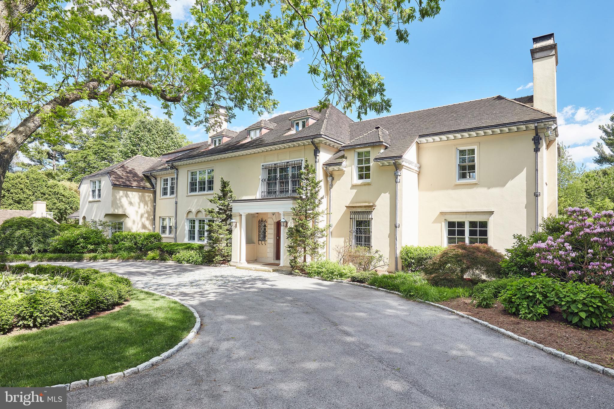 This stunning Estate property offers the rarest combination of impressively restored early 20th century architectural details and materials, exquisitely executed renovations, gracious room sizes, soaring ceiling heights, an open floor plan, sun-filled windows, elevator access to all living levels and a breathtakingly landscaped and gated 1.5 acre lot with courtyard, fabulous pool with spa, expansive terraces, 3 -car attached garage, 2-car carport, and a separate 945 square floor 1 bedroom Carriage House apartment with full kitchen, bathroom and laundry. Enjoy the best of perfectly blended old world charm with the modern designs, sophisticated finishes and luxurious amenities throughout. Recent improvements include beautifully refinished hardwood floors, freshly painted interior, fabulous new lighting, Wi Fi and A/V systems, restored original millwork and hardware, 6 new HVAC zones, 2 new water heaters, new premium carpeting, new washers and dryers, incredible new carrara marble Gourmet Chef's Kitchen and Butlers Pantry, refurbished pool, improved driveway with expanded Belgian block detail, fencing, landscaping and more. Timeless features include the stately 2-story entrance with massive restored oak staircase, stately Living Room with 11 foot ceilings, 4 fireplaces, spacious Dining Room, Bright Sun Room with side lounge opening up to rear terraces and glorious views, luxurious Master Suite with bright vestibule and naturally lit Dressing Room and wonderful marble bath with heated floors, 4 additional second level en-suite bedrooms with updated baths, and a third level offering 2-3 additional Bedrooms with 2 full updated baths and a convenient Laundry Room and bright Office. The spacious basement includes a full Bar, Media Room with fireplace and new AV systems, pool table room and lots of dry storage. Turn the key and move right in. Complete gated privacy yet close to renowned schools, all forms of transportation, Center City Philadelphia, Philadelphia International Airport and 90 minutes from NYC. A treasure!