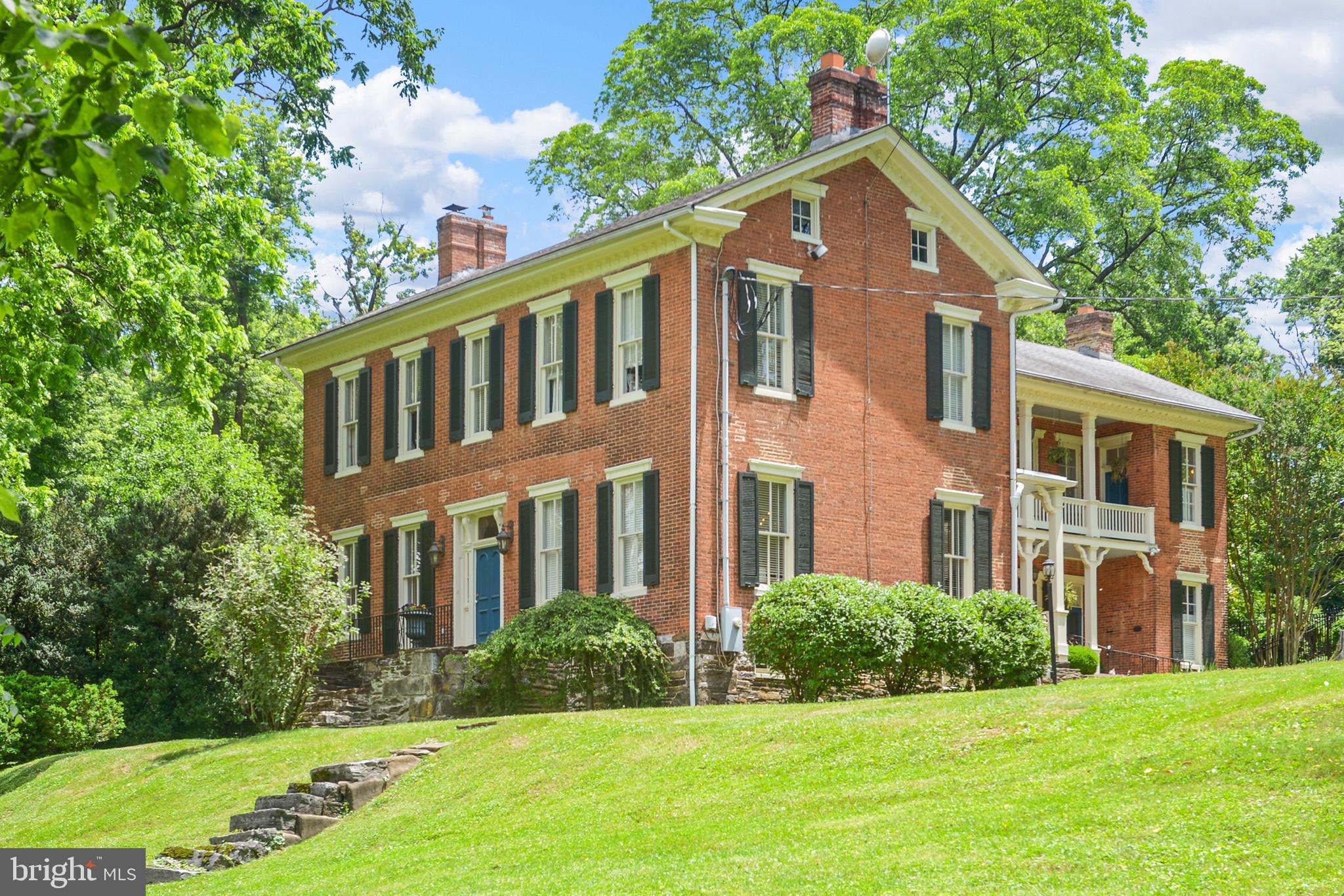 Historic Charm meets Modern Comfort on Five Gorgeous Acres at Linganore Farm! One-of-a-kind character and timeless elegance abound in this stunning all-brick home – listed on the National Register of Historic Places - nestled on five peaceful acres of your own private retreat. Even with the isolated setting, Downtown Frederick, shopping, and more are just minutes away! Step inside and you’ll be greeted by gleaming wood floors, soaring 11-foot ceilings, light dispersing transom windows, and exquisite decorative molding throughout. The home boasts five substantial bedrooms and five and a half bathrooms, including three en-suite bedrooms —potential for an enchanting bed and breakfast. The large, sun-filled kitchen is perfect for gathering, with plenty of natural light and space to create delicious meals and lasting memories. Grand and expansive, the dining room provides the ideal backdrop for elegant dinners and special occasions - opening to the covered back porch for effortless indoor-outdoor entertaining. Cozy up to one of the two fireplaces with gas logs for instant warmth and ambiance. Enjoy your morning coffee, outdoor dining, or peaceful bird watching from one of three inviting porches. The recently painted trim, porches, and shutters enhance the home’s curb appeal while maintaining its classic integrity. Outdoors, your private oasis awaits. From its beautifully restored smokehouse and original root cellar to a second structure with the potential for an income-producing unit, this property offers a rare blend of classic beauty and versatile opportunities. Take a dip in the in-ground pool or explore the estate, with ample room for gardens, chickens, goats, and a thriving homestead. Established mature trees including pecan, walnut, maple, and paw paw provide shade, beauty, and seasonal bounty. Whether you’re dreaming of a serene lifestyle, creating your own food forest, or starting a business venture, this unique property is full of possibilities. With its rich heritage, stunning details, and peaceful setting, this grand lady is ready to welcome her next chapter. Don't miss your chance to own a piece of history—schedule your private showing today!
