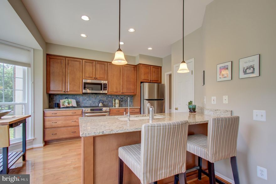 Beautiful Lowes Island Townhouse w/ So Many Upgrades. All NEW Windows & Sliding Doors. Newer HVAC. NEW Water Heater. NEW Hardwood Floors throughout main & upper, including stairs w/ matching banisters. Newer Kitchen Cabinets, Appliances, Granite Counters, Lighting, Fixtures, & Ceiling Fan.  Newer remodeled master bath w/ expanded shower, upgraded cabinets, lighting, & flooring.  Newer upgraded guest bathroom. Newer remodeled Full Bath on lower level w/ walk-in shower. Professional Landscaping.  Newer exterior trim w/ no-rot wood & paint.  Newer Updated Light Fixtures Throughout the Home. Simpli-safe alarm system conveys. Lower Level rec room walks out to beautiful paver patio & fenced yard.  Freshly Stained Fencing. Newer Cellular Blinds.   Upgraded window covering on upper level. Fresh paint throughout. 1- Car Garage. Fireplace. Gas Cooking. Enjoy all Cascades Amenities - 5 pools, 13 tennis courts, clubhouses, exercise room, trails, playgrounds, & more!