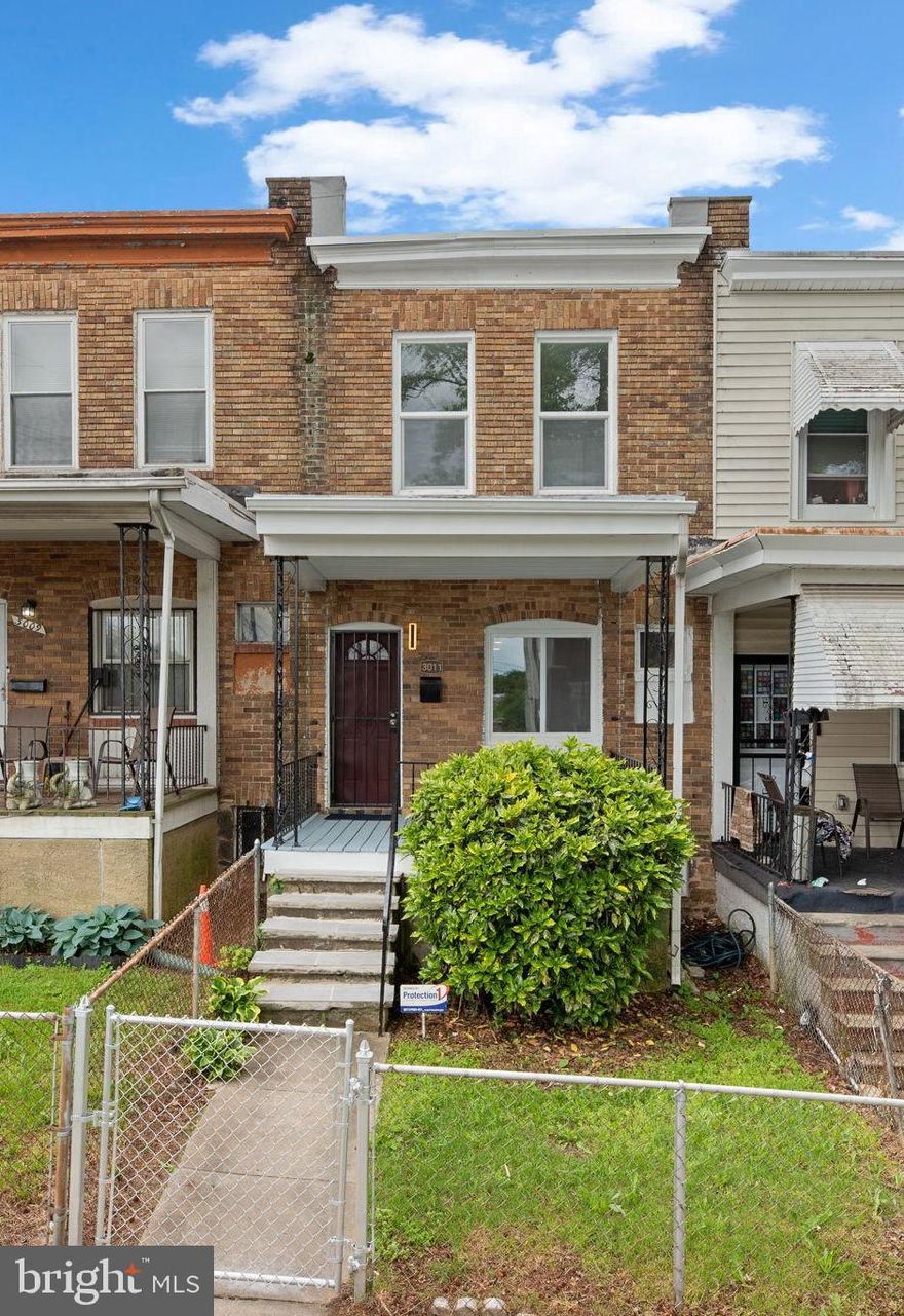 Charming townhouse residence offering 1,740 square feet, 3 bedrooms, 1 full bath, and 1 half bath in welcoming Franklintown. A fenced front yard and cozy front porch invite you into the open-concept main level. Inside, the spacious living and dining rooms feature gleaming floors and a convenient powder room. The updated eat-in kitchen is equipped with stainless steel appliances, a sleek mosaic tile backsplash, and direct access to the backyard. Upstairs, you'll find three comfortable bedrooms and a full bathroom. The finished lower level expands the living space with two flexible areas that can serve as a recreation room, media center, or home office, along with a dedicated laundry area and walk-out access to the backyard. The fully fenced rear yard includes a patio and a pathway leading to the back alley.