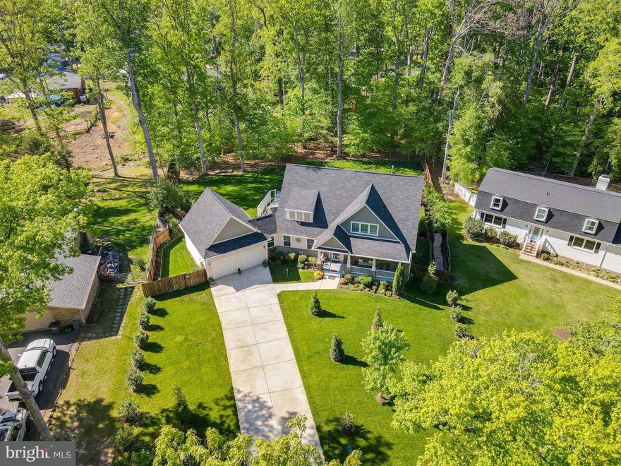 NO HOA!  Tucked away in the serene charm of Graham Park Shores, this stunning 5-year-old home is a hidden treasure. Surrounded by nature, it feels like your own private retreat—with frequent visits from bald eagles and a variety of wildlife, your expansive 0.7-acre backyard becomes a true serene sanctuary. Fully fenced-in backyard with LED lighting around the entire fence perimeter. Professionally landscaped yards with over 8,000 square feet of new sod, mature evergreen trees at the rear, it's the perfect blend of open space and privacy. Enjoy serene water views of Quantico Creek from the upstairs bedrooms, and relax year-round in your X500 POOL swim spa, which features hydromassage jets and a current for swimming. 
With over 4,500 square feet of beautifully designed living space, this home was built for connection and comfort. It offers six generous bedrooms—including a luxurious main-level primary suite—three full bathrooms, a powder room, and an oversized two-car garage. There’s space for everyone without compromising style or ease.
Step inside to rich hardwood floors, classic finishes, and inviting, well-planned spaces, extra insulation between levels. The kitchen truly is the heart of the home, featuring 42-inch white soft-close cabinets, granite countertops, stainless steel appliances, and  walk-in pantry—perfect for weekend baking or hosting gatherings.
The cozy family room invites you to relax by the gas fireplace, while a smartly designed mudroom off the garage helps keep daily life tidy and organized. The main-level primary suite is your personal retreat with a spacious walk-in closet, soaking tub, and separate shower—ideal for unwinding at the end of the day.
The fully finished basement expands your living space even more. With a bonus bedroom, full bath, wet bar, and ample room for movie nights, game days, or guest stays, it's ready for anything. A high-efficiency two-zone HVAC system ensures comfort and energy savings year-round. 220v plug for swim spa. 9 zone irrigation with front and back sprinklers to help maintain the gorgeous bright green lawn. 
Charming stone accents, a welcoming flagstone porch, and a classic driveway provide curb appeal that’s both elegant and timeless. And best of all? No HOA—just freedom, space, and a place that truly feels like home.   Bonus items that convey: Hydro-Tech in-ground irrigation system with WiFi, John Deere 42” lawn tractor & Craftsman 24” 208cc Dual Stage Snowblower, Beautiful slate pool table with accessories, Foosball table, Ping-Pong table-top with accessories, dartboard with accessories, Life Fitness full-body workout machine, Recumbent bike, Bar light, signs, and accessories all convey with the home. 
Enjoy Vacation at Home from now on with a Park Setting along with the Potomac & all of the wonderful amenities the Area offers -from world-class shopping and Dining at Stonebridge Potomac Town Center, The Rose Gaming Resort, Wegmans, and Potomac Mills Mall. Ideally located Just a Quick Drive away!! Less than 5 miles to the VRE, a Great Commuter Location. Easy Access to I95, RTE 1, MCB Quantico, Metro bus, Park n Ride, take VRE to Ft Belvoir & Pentagon and new DOD Facilities, or catch the Commuter Bus to DC. So close to Parks, Quantico hiking trails, and Quantico Creek!