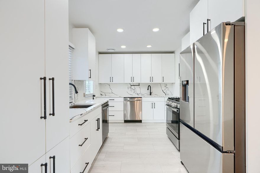 Welcome to your dream home featuring a designer kosher kitchen with double sinks, 2 dishwashers, modern soft-close cabinetry, quartz countertops and backsplash, and sleek stainless steel appliances. The main level is filled with natural light from large windows, complemented by gleaming hardwood floors that continue upstairs. Fresh white paint gives the home a bright and airy feel throughout.

Upstairs, you'll find 3 bedrooms with ceiling fans and an updated bathroom offering both a separate walk-in shower and a shower/tub combo. The finished basement includes a large rec room, powder room, and storage space.

Additional highlights include a new roof, carport, and a rear patio perfect for outdoor entertaining. Swingset is excluded from the sale.