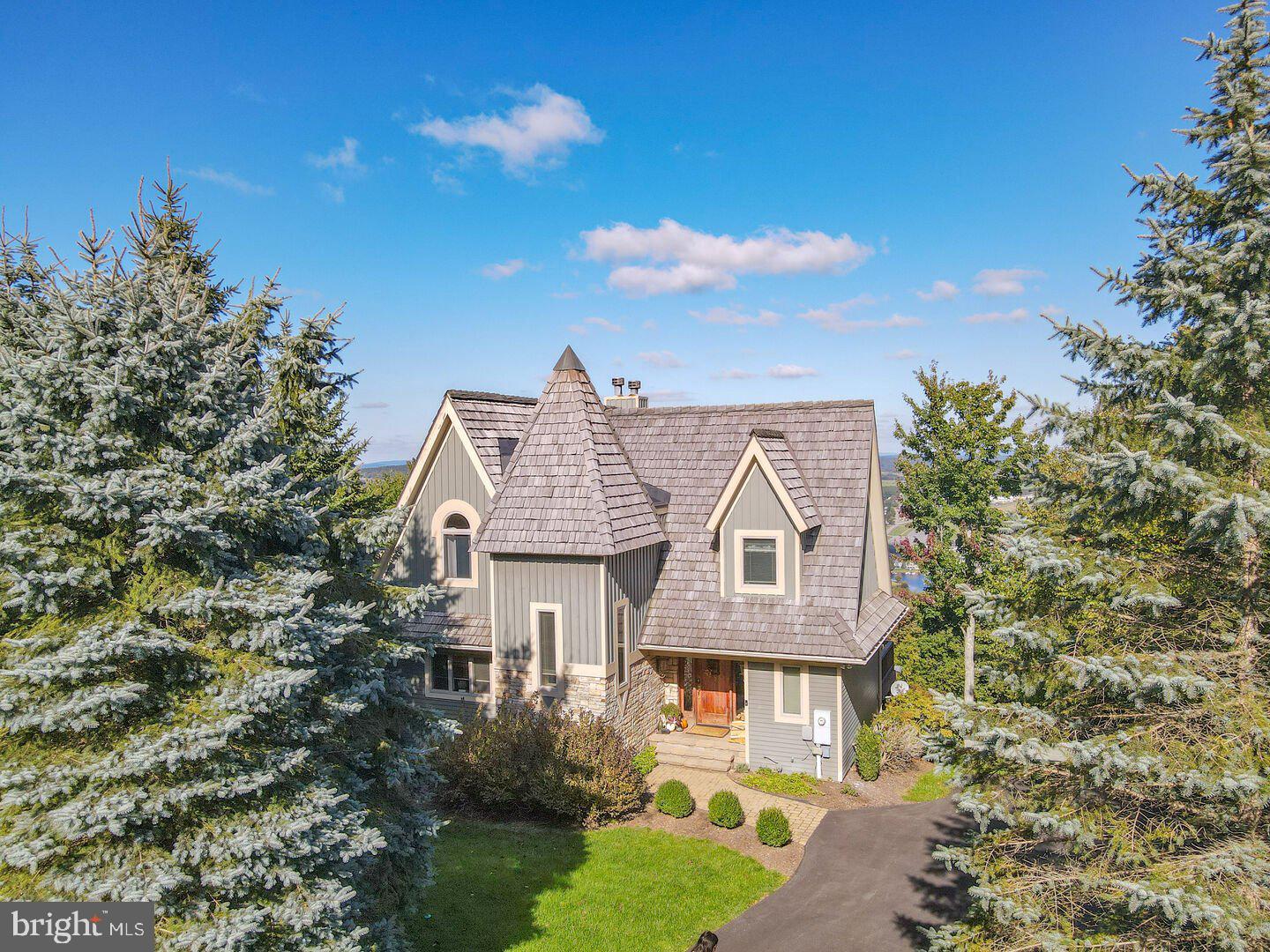 Mountain Charm Meets Luxury Living at 75 Boulder Ridge. Perched high above Deep Creek Lake with jaw-dropping panoramic views, this custom mountain lodge at 75 Boulder Ridge is the getaway you didn’t know you were waiting for. With its storybook gabled roof, rustic stonework, and dramatic cathedral ceilings, this home delivers the “wow factor” from curb to deck — and every elegant room in between. Step inside to an expansive great room drenched in sunlight from soaring windows and framed by exposed timber beams and a two-story stone fireplace. It’s the ultimate backdrop for fireside gatherings, cozy winter nights, and year-round entertaining. Whether you're gazing over the lake with your morning coffee, enjoying après-ski from the hot tub, or grilling on the spacious view deck, this home offers a front-row seat to all four seasons of mountain magic. Just minutes from boating, skiing, golf, ASCI whitewater course, and the best dining Deep Creek has to offer — this is luxury mountain living at its finest. Perfect as a full-time residence, second home, or high-performing vacation rental investment. Don’t miss your chance to own one of Boulder Ridge’s finest — schedule your private showing today!