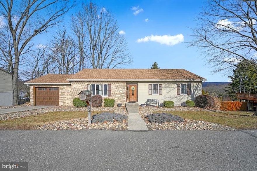 Pride in ownership is apparent as you enter this attractive ranch home.  The open floor plan feels spacious and comfortable.  The large kitchen features an island and ample table space along with sliding glass doors inviting you to enjoy the view and use of the raised private rear deck (25 x 20).   The main floor offers 3 bedrooms and a full updated bathroom with a double vanity.  The primary bedroom has dual closets and its own access to the full bath.  The partially finished lower level adds an approximate 540 Sq feet of additional living space.    Wow, this rec room is made for entertaining!  You will be impressed with the beautiful wooden bar offering seating for 8 and a convenient half bath.    An efficient coal stove offers a pleasant atmosphere and is an additional heat source that keeps the entire house warm.  Another set of sliding glass doors give access to the rear deck/patio and yard year round.  One car garage, newer roof (2018) and new carpet (2022) complete this appealing property.  Call to schedule your private tour today!