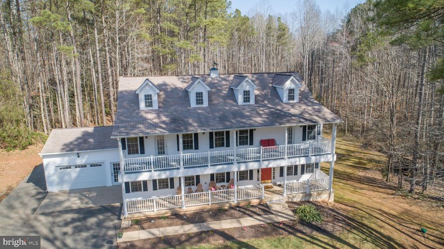 Welcome to this wonderful home with its luxurious upgrades and spacious upper/lower porch and deck. Beautifully updated 5 bedroom, 3.5 bathroom Colonial on 3.05 acres in the Cannon Knolls neighborhood. A spacious 3144 sqft upstairs awaits you with an additional 1589 finished sqft in the walkout basement that includes a bedroom, full bathroom, office, laundry room, play areas, and a plethora of storage. With all the recent updates, it is apparent as you tour the home that the pride of ownership really shines, truly a must see. The new engineered 5-inch plank hardwood Acacia flooring flows throughout the entire main floor as well as chair railings in most rooms. Through the front door, you will notice a sitting area with a fireplace to the right and a formal dining room to the left. The proximity of the dining room to the kitchen allows for a seamless transition when entertaining family and friends. Following the entry hallway straight ahead, you will see just how expansive the family room is with its two-story ceiling, plentiful natural lighting, and gorgeous fixtures all tied in by the fireplace. From the family room, there is a room to the right with built-in shelving that can function as an office or perhaps a play area. As we make our way into the completely renovated kitchen, the expansive theme follows, with ample counter space and built-in bench seating. The recently updated kitchen showcases granite countertops including on the new kitchen island, stainless steel appliances, an electric cook top, tile backsplashes, all new Mirillat Fox Harbor Maple Pecan wood cabinets, and even a work desk! The large, renovated deck, off of the kitchen, is the perfect spot for grilling and relaxing all while taking in the scenic, private beauty of the backyard, with plenty of space to entertain even the largest of family gatherings.  The backyard was recently improved with the removal of trees from one-half acre as well as proper grading to create a flat area that is just waiting for all of the lawn games to be played on. Moving back into the home, the primary suite is the perfect place to retire after a long day, whether it is relaxing on the upper porch off the primary suite or treating yourself to a bath in your very own soaker tub, this home has it. The recently updated primary bathroom features a beautiful tile floor, a gorgeous Mirabelle soaker tub, Italian Carrara marble wall with a frameless glass shower. The marble wall extends around the bath and to the new double sink vanity with a marble top. A skylight welcomes the warm rays of the sun into the primary bathroom. The entire upstairs was recently updated with new Mohawk stain resistant carpet. Three other bedrooms are located upstairs on the opposite end of a hallway that overlooks the living room. The upstairs full jack and jill bathroom includes tile flooring, a new vanity, and a tub/shower with glass doors, a lovely tile backsplash, and built-in shelving. The renovations are not exclusive to the first two levels, as you find when you explore the roomy basement. The beautiful and bright walkout basement has two rooms and a renovated full bathroom, a perfect setup for your media, and kids hang out area. The ease of access to the great backyard with great lighting, makes it a wonderful space for entertaining or those movie nights. Walking outside from the basement, you can’t help but notice the magnificent large Amish shed with two floors, a 14x17 foot base, and a 19-foot-high pitch. This shed is powered by a generator and is a great area to put all of those tools to good use. Along with the shed, there is additional outdoor storage area in the recently enclosed carport turned garage. Elegant color schemes (recently painted the whole home in 2019), thoughtful upgrades, and meticulous maintence are evident throughout the home and spacious decks and upper/lower porches await you on those days you just love to be outside. Less than 10 minutes to US-17 and shopping.