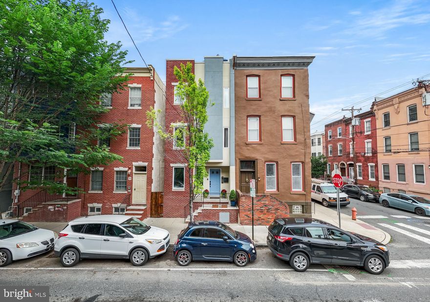 ***Seller's Are Including 1 leased parking spot for 2 YEARS with an acceptable offer. 
Stunning 4-Bedroom Contemporary Townhome in Graduate Hospital with Skyline Views and Luxurious Features.

Welcome to this incredible 4-bedroom, 3.5-bathroom home offering approximately 3,000 square feet of thoughtfully designed living space in Graduate Hospital. Boasting a modern aesthetic and unmatched amenities, this four-story residence features four unique private outdoor spaces, cutting-edge home technology, and top-tier finishes throughout.

The main level is ideal for entertaining with its open-concept layout, soaring ceilings, and abundant natural light. A spacious living room with recessed lighting and built-in surround sound leads to a gourmet kitchen outfitted with stainless steel appliances, granite countertops, a spacious center island with seating, and a built-in refreshment refrigerator. The adjacent dining area flows seamlessly into a private, enclosed  backyard complete with a custom wood trellis, beautiful landscaping, and a patio—your perfect urban oasis.

Upstairs, the second level offers an ensuite bedroom with a custom closet, and two additional well-appointed bedrooms (one with sliding glass doors leading to a low-maintenance Trex deck), a stylish hall bath, and a convenient laundry area.

The third floor is dedicated to a luxurious primary suite, complete with a spa-like bathroom jetted tub, frameless glass shower, and double vanity, as well as a custom walk-in closet. Just outside the suite, you’ll find a wet bar with granite countertop and refreshment refrigerator, leading out through sliding glass doors to a private deck—ideal for morning coffee or evening relaxation.

Climb one more flight to enjoy the expansive roof deck with soaring city skyline views—perfect for hosting friends or watching fireworks during Philly’s iconic events, including next year’s FIFA games!

The finished lower level offers a half bath, generous storage, and two separate spacious areas that can be used as a gym, playroom, office, or additional living space—offering flexibility to suit your lifestyle.

Additional highlights include:

Built-in whole-house surround sound system and in-ceiling speakers throughout.
Reverse osmosis water filtration system.
Dual-zone HVAC for year-round comfort.
Recently replaced roof (2023).

This location is unbeatable—just steps from South Street West, PHS Pop Up Garden, Avenue of the Arts, Rittenhouse Square, shopping, supermarkets, restaurants, theater, and more. Bike commuters will appreciate the nearby Indego bike station less than two blocks away.

Don’t miss the opportunity to own this exceptional home in one of Philadelphia’s most vibrant neighborhoods. Schedule your private tour today!