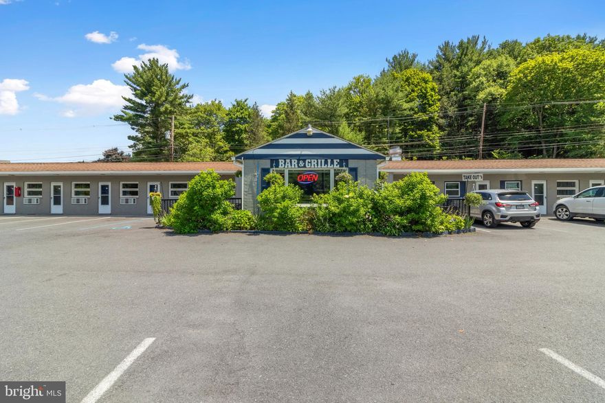 The We Are Inn is Philipsburg’s go-to Penn State alumni destination, conveniently located across from Cold Stream Dam and Park. This lively hot spot offers 16 spacious motel rooms, each outfitted with a plush king-size bed, private bath, mini refrigerator, cable TV, WiFi, a desk, ottoman, and roll-out dinette table perfect for comfort and convenience. The restaurant area features two energetic bars and three distinct dining rooms with both indoor and outdoor seating options, creating a festive atmosphere for game days or relaxing evenings. Guests enjoy access to four pristine restrooms, while staff benefit from a dedicated employee restroom. Set on a generous 1.38-acre parcel, the property boasts ample parking with 48 spaces in the front and 36 in the rear. Adding to its charm, the on-site ice cream shop serves irresistible soft-serve treats beloved by locals and visitors alike. Just minutes from Black Moshannon State Park, Happy Valley, and situated along the Rails to Trails path, the We Are Inn is the ideal getaway for sports enthusiasts, nature lovers, and travelers seeking the perfect mix of adventure, comfort, and community spirit in central Pennsylvania.