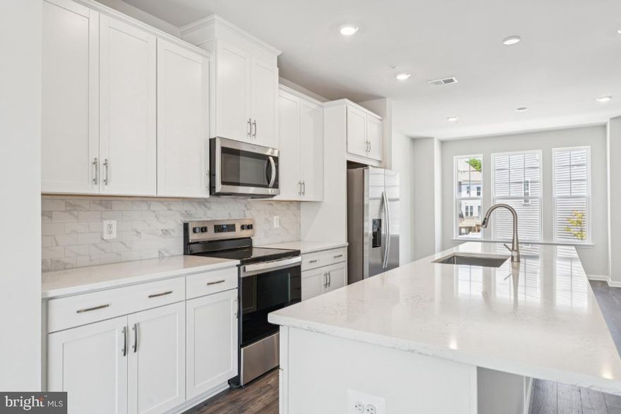 IMMEDIATE DELIVERY - Beautifully designed new construction townhome in the heart of Damascus, MD! This modern 3-bed, 2.5 bath home offers 2017sq. ft. of thoughtfully designed living space, perfect for comfortable and stylish living. As soon as you enter the front door, you are greeted by a bright foyer leading to a lower level rec room, leading out to a private backyard. Heading up the oak staircase to the main living level, you will find an Open-concept floor plan with spacious living and dining areas. The sleek kitchen features an oversized island with quartz countertops, stainless steel appliances & custom cabinetry. The dining room features a box bay window bumpout. The spacious Great Room opens up to a Trex deck overlooking trees.  Upstairs, the Luxurious primary suite is complete with a walk-in closet and spa-like en-suite bath. Laundry room is conveniently located upstairs, along with 2 other bedrooms and hall bath. Energy-efficient features including smart home technology and high-performance windows. The exterior includes a 1-car Attached garage and additional parking for convenience, as well as Private outdoor space perfect for relaxing or entertaining. Located in a vibrant new community, this townhome offers easy access to major highways, shopping, dining, and top-rated schools. Enjoy nearby parks, walking trails, and all the charm that Damascus has to offer! Special incentives available for a limited time! Don't miss the opportunity to own this brand-new townhome in a fantastic location. Schedule your tour today!