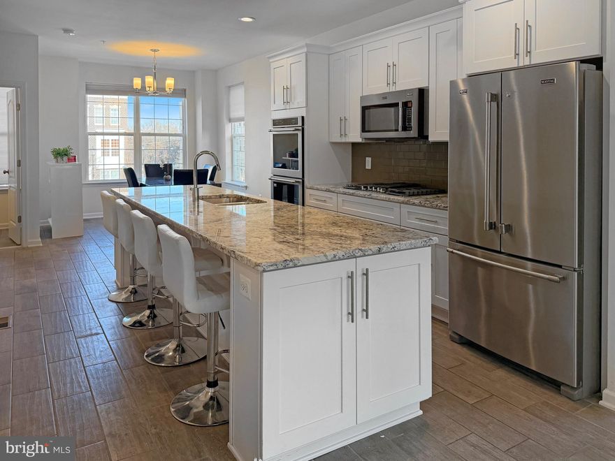 Why wait for new construction? Welcome to 9713 Weshire Drive, a corner 4-level townhome built in 2020, offering modern finishes, abundant natural light, and a low $92/month HOA—a standout value compared to nearby new builds.

The open main living level features a gourmet kitchen with an oversized island, stainless steel appliances, and a seamless flow into the dining and living areas. A cozy fireplace and convenient powder room complete the space—ideal for everyday living and entertaining.

Upper levels provide multiple private retreats, including a spacious primary suite with walk-in closet and en-suite bath, additional bedrooms and full baths, plus a top-level loft/bonus room with full bath—perfect for a home office, guest suite, or flex space. An upper-level terrace adds outdoor living, while the tandem garage offers secure parking and storage.

Corner home • No carpet • Like-new condition • Immediate occupancy available
Pre-appraised and competitively positioned against surrounding new construction.

Conveniently located near I-495, Route 50, and I-295/I-395 with easy access to Metro, Joint Base Andrews, Downtown D.C., National Harbor, Ritchie Station Marketplace, shopping, dining, and everyday conveniences.