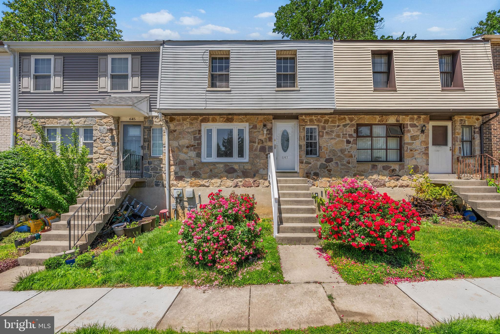 On a quiet, low-traffic street, just off Lansdowne Ave, you'll find 643 Saint Anthony Ln. This spacious, move-in-ready townhome has 3 beds, 3.5 bathrooms, a finished basement, and a deck. Out front, there's generous parking for residents and guests, while a pair of lush rose bushes adds charming curb appeal to the stone and siding facade. Inside, gleaming hardwood floors stretch across the bright and airy living room, where bay windows let in plenty of natural light. You can easily create a welcoming space for everyone to hang out. Past a powder room and coat closets down the hall, there's a second large flex space that can serve as a den, dining room, or breakfast nook. It's open to the home's kitchen, which is fitted with stainless steel appliances, including a dishwasher. Sliding glass doors lead to a huge, covered rear patio, where you can host summer barbecues and dine al fresco. Up on the second level, the spacious, sunlit primary suite at the front has hardwood floors, two double closets, and an attached full bathroom with a glass-enclosed shower. Another bathroom and two more bright bedrooms are off the hall. More living space is found in the expansive finished basement, along with a kitchenette, a full bathroom, and a laundry room, making it ideal for a family room, playroom, gym, or guest suite. Off the back is an enclosed room below the deck, perfect for storage and access to the rear yard. 643 Saint Anthony Ln's fantastic location is less than five minutes from popular shopping centers with stores like ACME, Lowe's, Kohl's, and Giant. Sprawling parks and ballfields are close, plus there's easy access to public transit, State Rd, Rt-1, and Rt-3. Schedule your tour today!