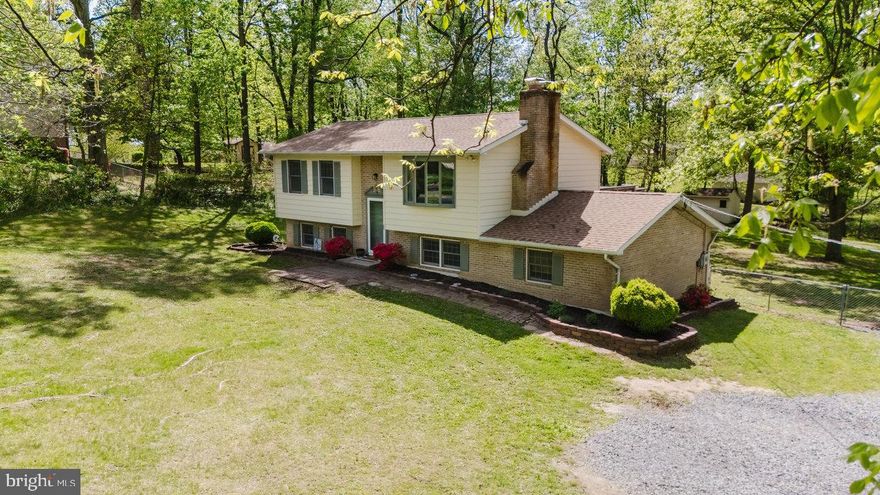 Welcome to your dream retreat nestled along the serene Potomac River! This charming split foyer home offers four bedrooms, two full baths, and finished recreation room.   This home has been renovated with luxury vinyl plank, updated baths, and updated kitchen and granite counter tops plus recently a new water heater. The 4th bedroom can be flex or office space, even has its own outside entrance or can be accessed from inside. The exterior has a large deck with stairs to the back yard and patio for entertaining. With over an acre of lush land, the front and rear yards provide plenty of space for outdoor activities, the back is fully fenced. Located in a vibrant community with boat ramp access and water privileges, this property is a haven for water enthusiasts. The attached garage and additional storage area enhance functionality. Don’t miss this opportunity to own a slice of paradise where comfort meets nature!