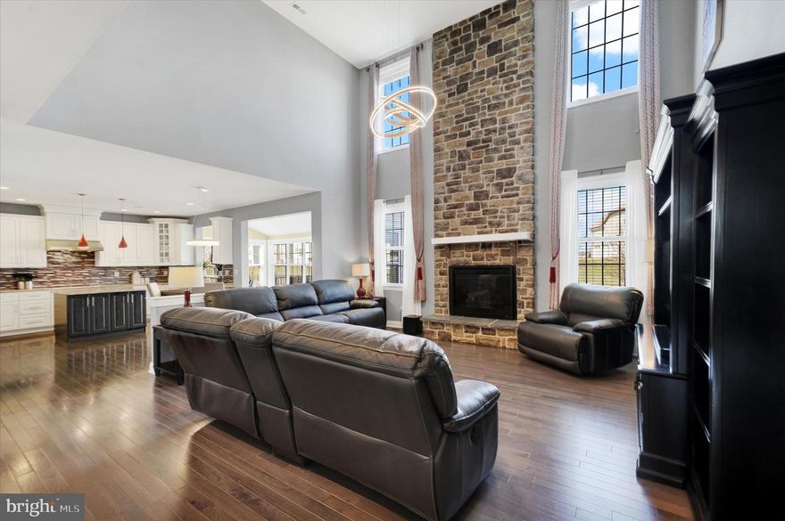 This exceptional, move-in ready Executive home offers over 4,400 square feet of beautifully finished living space, designed for today’s discerning buyer seeking luxury, convenience, and outstanding value. Enjoy upscale suburban living with the added advantage of Delaware’s comparatively low property taxes.
Ideally located in a highly sought-after community with easy access to Route 1 and I-95, this home offers effortless commuting to Wilmington, Philadelphia, and beyond.  It serves as a convenient midpoint between New York City and Washington, D.C. Residents enjoy resort-style amenities including a clubhouse, outdoor pool, fitness center, tot lot, and walking paths, all for a reasonable monthly fee, along with the flexibility of Delaware’s School Choice Program.  The Country Manor elevation impresses upon arrival with a stone-accented façade, carriage-style garage doors, and extensive custom hardscaping, including an expanded paver driveway, lighted entry pillars & walkways leading to a welcoming front porch.
Inside, the classic center hall colonial layout is professionally painted & enhanced with modern finishes. The foyer opens to formal living and dining rooms, while wood flooring spans most of the main level, complemented by 9-foot ceilings for a bright, open feel. A private home office with double doors overlooks the rear yard and is ideal for a remote workplace.  The dramatic two-story family room features a floor-to-ceiling stone fireplace and flows seamlessly into the gourmet kitchen, complete with a center island, granite countertops, tiled backsplash, soft-close cabinetry with glass accents, pantry, and premium KitchenAid appliances. The adjoining sunroom with vaulted ceilings is filled with natural light and opens to the outdoor living spaces.  The rear yard  faces the open space between two houses and is beautifully enhanced by a composite deck and paver patio with built-in seating to relax or enjoy during your parties and barbecues.  A functional mudroom with utility sink and large coat closet connects to the garage, featuring durable epoxy flooring.  Upstairs, an open hallway overlooks the family room below, filled with natural light and expansive views. A bedroom-level laundry room with new washer and dryer adds everyday convenience. Bedroom Two offers a fabulous walk-in closet and shares a well-appointed hall bathroom with Bedrooms 3 and 4.  The Owner’s Suite is a true retreat, featuring a spacious bedroom with double-door entry, a versatile sitting room ideal for a private office or comfortable lounging room, and a luxurious en-suite bath with frameless glass tiled shower, soaking tub, and expansive walk-in closet.
The finished lower level creates generous living spaces with a large recreation room, a versatile finished bonus room, and a full bathroom. Everything you need for extended guests stays, celebrations or simply for you to enjoy.  An unfinished bonus space also with epoxy painted floors provides flexibility for a future home gym or your own customization.  With all this great finished space, there is also plenty of storage room too!  This exquisite executive home seamlessly blends everyday comfort with ideal features for elevated hosting & gatherings  offering the space, style, and location today’s luxury buyers deserve.
Editing has been completed to the photos shown.  All room measurements & square footages listed are estimates and to be verified by Buyer.  Schedule your tour today to see this impressive home!