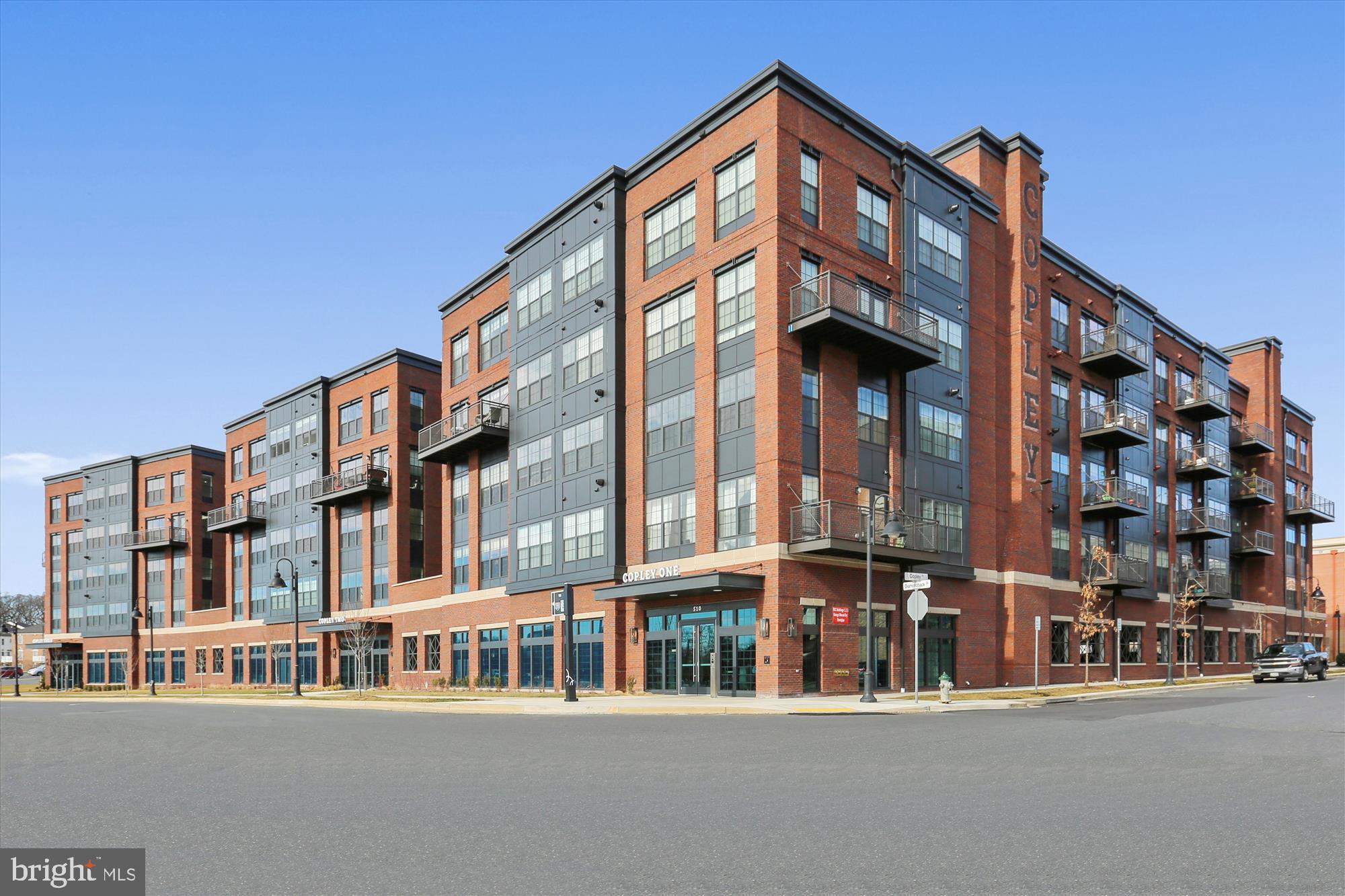 Welcome to The Copley in Downtown Crown! This two bedroom plus den condo with two full baths has the best of everything- secure building and elevator access via the beautiful lobby, a balcony facing the interior courtyard, two of the best placed parking spaces directly outside the lobby doors, and two 5x7 storage units located directly across the hall!
Enter from the hallway into the foyer onto immaculate engineered hardwood floors, leading to the open-concept kitchen /living/dining area and the sunny balcony beyond. To the right of the foyer is a den that makes a wonderful office space, with a barn door, upgraded with recessed lighting. The kitchen is exceptional including custom soft-close cabinetry with additional accommodation for large pots and pans, a kitchen island with barstool space that conveys, stainless steel appliances, and quartz countertops. A pantry closet outfitted with elfa shelving completes the space. The high ceilings in the unit are evident as soon as you enter! The kitchen allows for additional dining table space and flows into the spacious family room boasting floor to ceiling windows- a glass door provides access to the balcony with space for sitting outside to enjoy coffee in the mornings, and overlooks the beautifully manicured courtyard space below.
The Primary Suite is located left of the Family Room with large windows and plentiful natural light, and easily fits a large king bed with multiple dressers. There are two walk-in closets outfitted with professionally installed shelving and organizers (as were all closets in this condo) on either side of a short hallway leading you to the large primary bathroom. The primary bathroom boasts a massive vanity with two sinks and expansive counter space, contemporary lighting and modern tile finishes, a huge frameless walk-in shower with room for a seat, and a separate closet within houses the stacked high efficiency front loading washer and dryer, for ultimate daily convenience.
On the opposite end of the Family Room sits a second large bedroom with ample space for guests with another very large outfitted closet, and also has huge double windows facing the courtyard, maximizing the natural light. The adjoining hallway connects the second bedroom to a large full bathroom to serve the common areas as well, equipped with a combination tub/shower, modern lighting and tile finishes coordinating that of the primary bathroom, and plenty of vanity space. Built in 2018, have confidence in efficient utility costs with a tankless water heater and young HVAC system and appliances. Our seller has made it all complete with additional recessed lighting, ceiling fans in each bedroom and the family room, and custom closets as well as custom paint.
The Copley is a beautifully maintained secure access building at an amazingly efficient $445 monthly fee (which includes water). For an additional$300 on an annual opt-in basis, residents can choose to join the community pool at the Retreat and addition to pool access, membership there includes tennis courts, a bocce ball court, a horseshoe pit, a playground for the younger members, and a community center that is available for rental by active members.
The Copley building is conveniently walkable to Harris Teeter, Starbucks, Lifetime Fitness, Ruth's Chris, Coastal Flats, Lululemon and more. It is also just minutes from Target, AMC movies, Yard House, Barnes and Noble in nearby Rio. Enjoy quick highway access to 270, 200, and 370. Enjoy a free shuttle to the Shady Grove Metro from Downtown Crown at your front door - love where you live!
