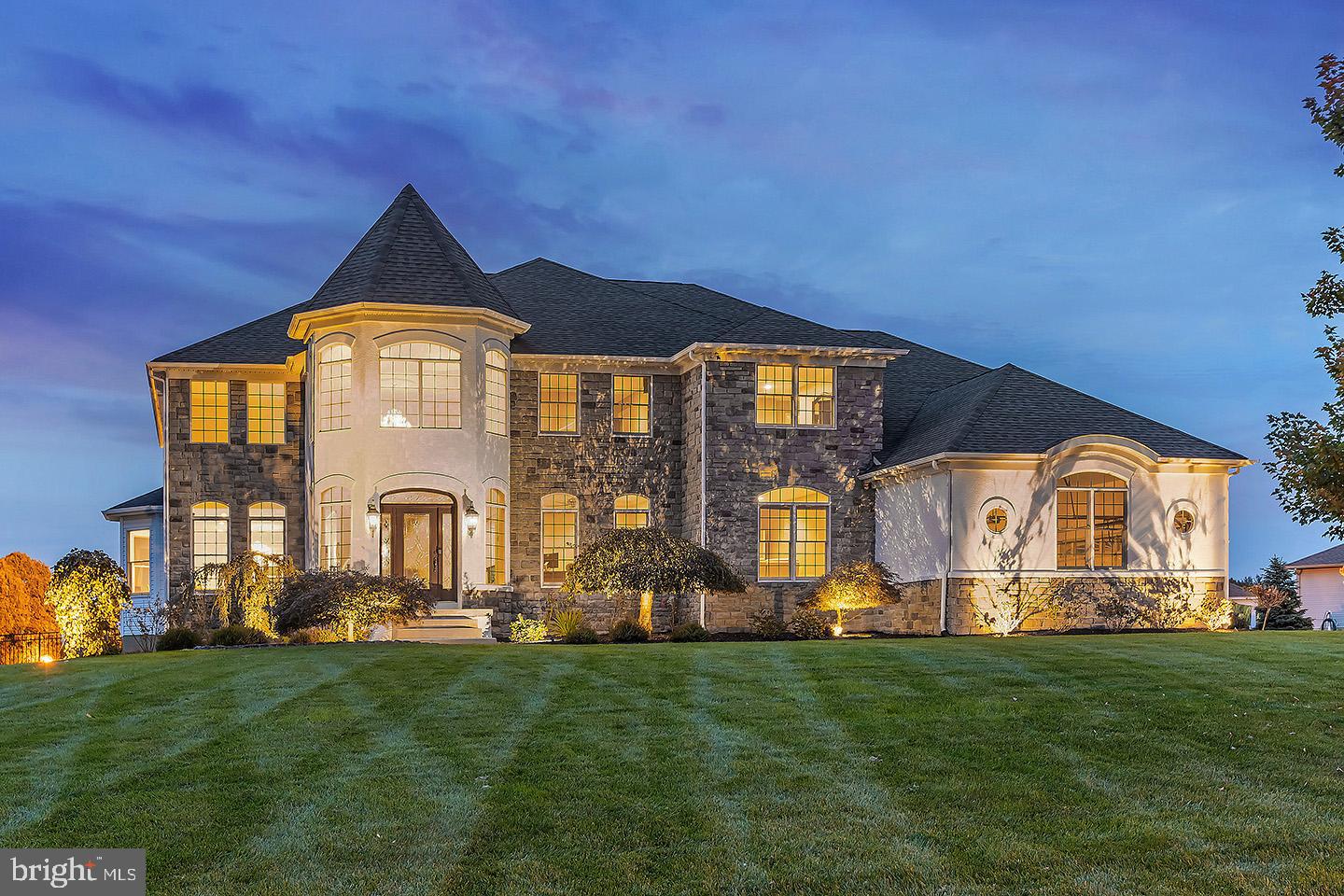 Situated on a premium cul de sac lot with private views of the bordering vineyards sits this elegant executive style home in the highly rated Clearview School District. This gorgeous stone front Tuscany model is luxury defined has over 6600 sq ft of finished living area (including basement) and is one of only three of this model available in Brookside Farms! From its curb appeal of professionally manicured grounds and landscape lighting to the dramatic 2 story turret foyer and side entry 3+ car garage, at first glance it's beyond impressive! Greet guests from your spacious grand foyer with new cherry hardwood flooring, striking Schonbek chandelier (with motorized light lift), and dramatic curved staircase. The home office to your right offers a private workspace, while the bright and open formal living room continues to your left and flows easily into the huge dining room. The dining room offers views of the beautiful vineyards and your rolling emerald green yard, and enhanced by custom millwork, lighted wall niches, Schonbek chandelier and tons of recessed lighting. Pass through the convenient butlers pantry into a gourmet kitchen with stainless GE Monogram appliance package. Gleaming granite counters and an enormous island are accentuated by the sparkling Schonbek crystal light fixtures. Enjoy sweeping views of your picturesque backyard from the large breakfast room. The open layout seamlessly flows from the kitchen into the sun drenched family room with new hardwood flooring, 18’ ceilings, wood burning fireplace and amazing wall of windows (the only Tuscany model with this) and second staircase. The first floor primary suite offers an ideal space for multi-generational living or au pair quarters. Here you will find new hardwood flooring, recessed lighting, walk-in closet and 4 piece bath. A powder room and laundry room complete this level of this amazing home. The upstairs main hall boasts crystal Dale Tiffany ceiling fixtures. A massive upper level primary suite features sitting area w/cozy gas fireplace, recessed lighting, tray ceiling and dual closets with California Closets organization systems. Recharge in the custom en suite, featuring a 2 person multi-jetted shower, 2 person jetted tub, dual sinks with new quartz countertops, and separate water closet. Across the hall are two more large bedrooms with Jack and Jill bath and walk-in closets; a jr. suite w/private bath and 2 big closets is down the hall. The finished basement has cork flooring, ample recessed lighting and custom millwork. There is a family room area for lounging or TV watching; and the gamer or sport enthusiast will love the separate area with 4 more mounted TVs! The two tiered granite bar will be the best seat in the house to watch football games or host parties. No need for a gym membership anymore, this home has a large home gym too! A full bathroom and attached hobby/playroom offer even more options for space. Enjoy a view of the Philadelphia skyline from under the covered outdoor pavilion with stone fireplace or from the custom Pebble Tec black bottom saltwater pool and spa. There is extensive hardscaping from the walkways to the patio and built-in firepit, as well as at the outdoor kitchen! Enjoy a pick up game on the multifunctional basketball/hockey/tennis court. The well planned features of this immaculate home have been maintained by its original owners, who just had the home freshly painted top to bottom, so it’s ready for the next owner to easily settle into the luxury lifestyle that this home offers. NEW septic tank and field. OVER $200+K in builder upgrades! Notable features: tinted Anderson windows, well for irrigation system, newer high efficiency 3 zone HVAC, insta-hot pump for tankless water heater, camera security system, whole house surround sound/intercom systems and a large 26x16 shed for extra storage. Easy access to Philly and shore areas , historic Mullica Hill and only 2 miles to the new Inspira Hospital.