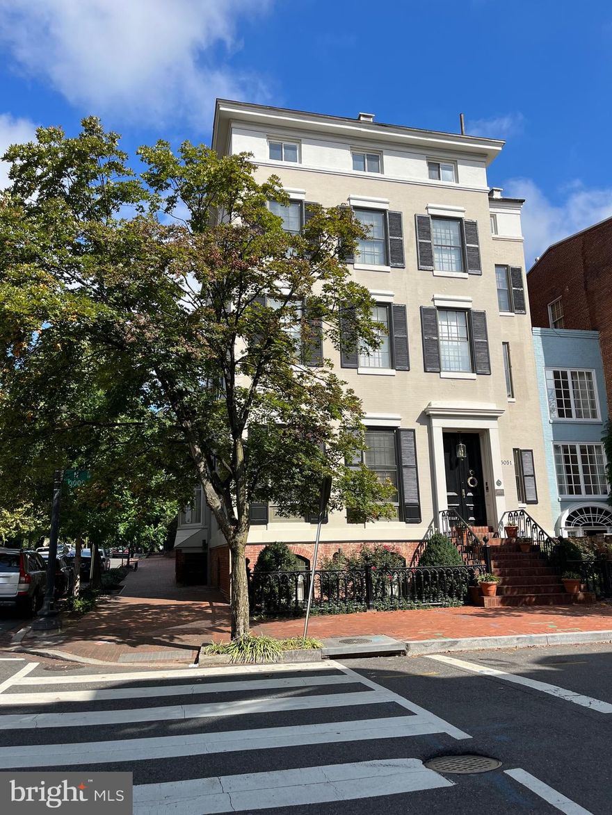 11,000 SF prominent, stately home on the corner of 31st and N St in the East Village of Georgetown. A total of 7 Bedrooms, 6.5 Baths with two-car garage parking. This historic home features a grand foyer, staircase, vestibule, elegant entertaining rooms with 14' ceilings, handsome library with floor-to-ceiling bookshelves, exquisite moldings, marble mantels, 10 fireplaces, sun room, and landscaped patio with pond. The top level boasts unobstructed views of downtown Georgetown, Monuments, Chain Bridge, and the Potomac River. The lower level has a sauna, wine room, bar, rec room, office space, and a full bath. Located on the top floor, is an apartment with a spacious living space, two bedrooms, full kitchen, and separate stairway for privacy - perfect for an au pair.
