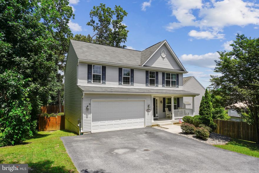 This beautiful home has all you're looking for in a Great Location near Rt 97, Rt 100, Ft. Meade, NSA, BWI, Homeland Security. With almost 3900sf of finished space there's room for everyone to spread out. A large primary bedroom with ensuite bath and three good size bedrooms serviced by a full bath make up the top level, and for convenience the Washer and Dryer are on this level. The main floor has everything you'd expect, a large welcoming foyer off the covered front porch opens to the living room. There is a half bath off the kitchen/great room which extends the entire width of the rear of the house, and you can also access the large two car garage from here. The kitchen/great room opens to a good size deck for dining & grilling, and to the rear fully fenced flat yard. The back yard is nicely landscaped with a large paver patio, mature trees, swing set, and access to the lower level finished basement. The lower level includes a wet bar and half bath and lots of room for all sorts of activities. At just 11 years young this home is in great shape and has been very well cared for.