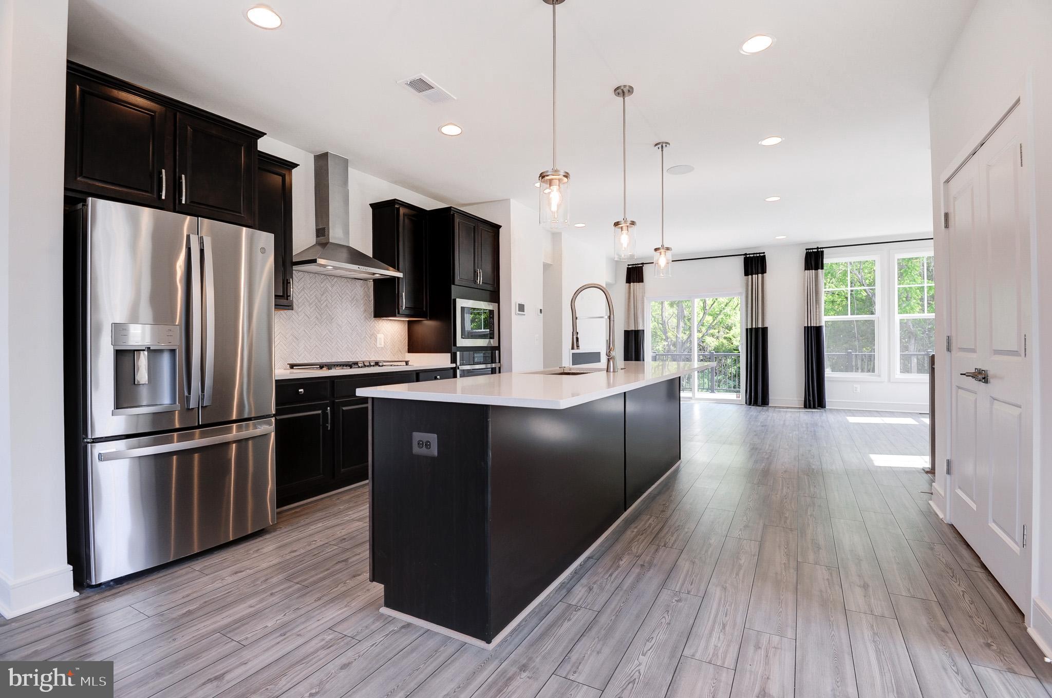 Previously a BUILDER MODEL HOME at Lake Frederick! END CORNER TOWN HOME backs to WOODS!! Never lived-in!!! <br> <br> Rent includes HOA fee & Lawn maintenance that includes mowing at front, back, & side yards. Mulching included as well <br> <br> Lake Frederick is a gated, master-planned resort setting sub division, where privacy & peace are @ its forefront. This charming community is tucked in the serene Shenandoah Valley, midway between Winchester & Front Royal cities where one can enjoy conveniences of both cities & yet, experiene the tranquility of nature. Breathtaking mountain views, amazing sun rises, & serene sun sets over the Blue Ridge Mountains <br> <br> This sub-division boasts outstanding engaging lifestyle amenities. CLUB HOUSE: Outdoor pool & gym | SHENANDOAH LODGE/ATHLETIC CLUB: Access to UPPER level activities | ONSITE REGION'S 117 RESTAURANT & BAR: Award-winning, highy rated, farm to table restaurant. A great meeting place to enjoy lunch/dinner or to watch a game together | ONSITE LAKE FREDERICK: Stunning 117-acre lake! Breathe into an early morning scenic walk or run or a relaxing kayaking or fishing at this lake | Sports courts, tennis courts, pickleball, tot lots, community parks, dog parks, fire pits, & miles of walking trails <br> <br> Minutes away to Shenandoah National Park, scenic Skyline Drive, & Appalachian Trail | Nature, shopping, dining, fitness, movies, restaurants, meeting places, parks, six nearbygolf courses | Quick access to major interstates I-66 & I-81, Rte 340, Rte 7, ensuring a seamless connectivity to the region<br> <br> Lake Frederick has it ALL! Excellence in style, function & location. Offers an exceptional balance between modern living, joys of natural beauty, sun-drenched life, great outdoors & a laid-back lifestyle centered around enjoying time w/ friends, providing residents a unique & enriching living experience <br> <br> 3 level, 2,250 sq ft interior FINISHED, 3 spacious bed rms, 3 full baths, & 1 half bath | Front door to the side of the home | Attached, front load, 1 car garage, but 2 car driveway, equipped w/garage door opener & keypad. Ample car parking spaces for quests | 9 ft. ceilings | Natural light gushing in thru abundant windows thru out the home| Oak staircase all thru the flights | LED lighting thru out the home | Security cameras available if required | Ceiling speakers | Walk-out homesite <br> <br> Vanmetre built, Nicholson floor plan, offers an open moden concept that accomplishes contemporary living w/all the space & style, versatility & functionality; where comfort & convenience merge seamlessly <br> <br> The MAIN level is the heart of the home w/beautiful LVP floors all thru | The GOURMET kitchen in the center w/large center island is a hosting spot w/its seamless flow, creating a distinct dining & living areas to its either sides making entertaining a breeze. SS appliances, cooktop w/hood, & wall oven layout (not many townhomes here have this layout),refrigerator w/water dispense, large undermount sink, quartz counters, backsplash, & pendant lights | Tucked in nook to cater to your needs & imagination; an ideal home office or kids homework area or a creative craft area | A powder rm | Long pantry closet | Huge deck off of the living area gives an extention to the living space <br> <br> At UPPER level are the 3 spacious bed rms; the primary bed rm w/tray ceiling & a large walk-in closet. Primary bath has dual vanities, a walk in shower w/frameless enclosure, & a big size window | The two scondary bed rms down the hall share a full bath rm | Linen closet | Washer & Dryer closet w/cabinets <br> <br> The LOWER level features a cozy rec area w/closet, storage area, & full bath; rec area is perfect for a game room or home office | Nice patio space off of the rec rm, enhances outdoor living