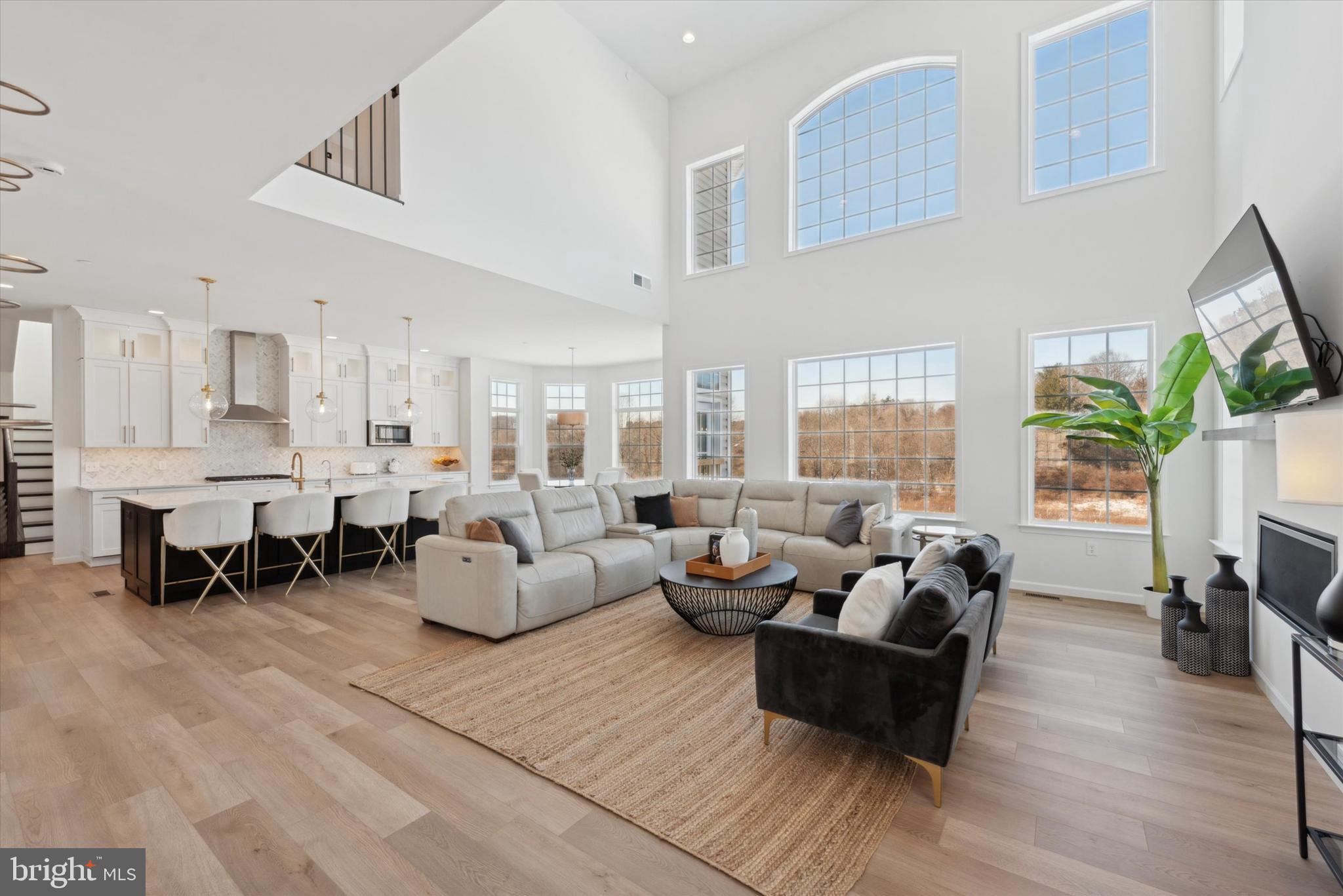Nestled in the prestigious Ventry Community at Edgemont Preserve 115 Parkview was custom built in 2023, a Devonshire Manor model, with 5100 sq. ft of living space, 6 bedrooms, a three-story bump-out, all bedrooms built as en suites baths, and 2400 sq. ft of Walkout Basement that is unfinished, offering abundant space for storage or future expansion. Located within the highly sought-after Rose Tree Media School District, 10 minutes driving distance to all the restaurants at Ellis Preserve, this home offers a harmonious blend of modern luxury and timeless elegance, surrounded by the serenity of nature.
The home was designed with sophistication and functionality in mind and the owners spent $400,00 in upgrades when they built this home. Stunning wide-plank wood floors, soaring ceilings, and architectural details that set the tone for the home’s luxurious ambiance. An elegant Dining Room, leading to the Butler’s Pantry and the Gourmet Chef’s Kitchen, creating distinct yet interconnected spaces ideal for entertaining and convenience. The Chef’s kitchen, a culinary haven equipped with high-end appliances, including a SubZero fridge, farmhouse sink, upgraded cabinets, wine cooler, quartz countertops, and a generous eat-in island. The kitchen leads to a Breakfast area and a grand 2-story Family Room with stunning views of the private backyard, a cozy gas fireplace, perfect for hosting gatherings. A stunning glass conservatory and creatively conceptualized library space is a wonderful extra! Back through the kitchen is the Second Staircase, powder room, mud room with Custom Built-Ins and an expansive office/bedroom with an ensuite bathroom and walk-in closet.
Upstairs, the luxurious owner’s suite is a tranquil retreat, featuring large bay windows, a tray ceiling with a ceiling fan, and two his and hers custom walk-in closets. The ensuite bathroom is a spa-like haven, with marble and granite finishes, spacious shower, a jacuzzi tub, Dual vanities, wall-to-wall tiled backsplash. Four additional bedrooms, each with walk-in closets and bathroom access, offer comfort and privacy, while a dedicated laundry room adds convenience to the upper level.
Outdoors, enjoy a Private backyard, with scenic vista views. Community amenities include a Clubhouse, fitness center, basketball court, and pool, with space for a private pool on the property. 115 Parkview Way is more than a home—it’s a lifestyle. Experience unparalleled comfort and luxury in this meticulously crafted residence. Schedule your private showing today!