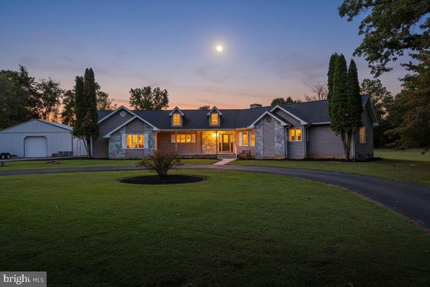 Welcome to 174 Martin St., just minutes from the heart of quaint Luray, VA and only 7 miles from Skyline Drive. This charming home offers the perfect balance of small-town living, endless Shenandoah Valley adventures, and the tranquility of having your own peaceful retreat to come home to. With over 3,300 square feet of living space, this home is located on a quiet street, this contemporary home immediately welcomes you with its curb appeal—featuring a circular driveway, landscaped front yard, and a walkway leading to the inviting front porch. Inside, the grand living room showcases floor-to-ceiling windows with stunning views of the backyard, a vaulted ceiling, and a cozy stone woodstove. The dining room is filled with natural light thanks to new windows and sliding doors that open to the back deck. The bright kitchen offers white cabinetry and a walk-in pantry for plenty of storage. Down the hall, you’ll find a full bathroom, two bedrooms, and a spacious primary suite complete with a whirlpool tub, separate shower, and dual-sink vanity.
Step outside to the pavilion-covered back deck, perfect for relaxing or entertaining while overlooking the large, level backyard. Need more space? The finished basement offers a full bathroom, kitchenette, laundry room, and multiple finished areas that can serve as an entertainment room, gym, playroom, or extra storage.
Set on 2.44 acres, the property provides endless opportunities for gardening, play areas, or simply enjoying the Virginia seasons. The attached two-car garage, detached two-car garage, and workshop offer abundant parking, storage, and hobby space. Recent updates give you peace of mind, including a new HVAC in 2024, plus a roof and solar panels installed in 2022—so the big-ticket items are already taken care of.
Whether you’re seeking room to spread out, modern updates for peace of mind, or a beautiful setting to enjoy the best of the Shenandoah Valley, this home truly has it all. Don’t miss your chance to make it yours.