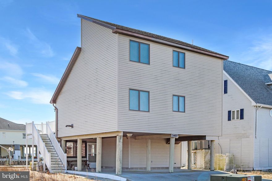 Wake up to stunning water views in this beautifully positioned waterfront home on a canal with sweeping vistas of the Chincoteague Bay. Designed to capture the scenery, this 3 bedroom, 2 bathroom home offers views from nearly every room. The open floor plan creates a bright and inviting living space, highlighted by a cozy pellet stove. A spacious loft provides flexible living or guest space. Enjoy outdoor living with a new composite deck and private balcony overlooking the water, plus an enclosed patio area on the ground level ideal for entertaining or relaxing. The home also features a convenient laundry/utility room. Located in the amenity-rich Captains Cove community offering golf, pools, waterfront dining, boat launch, fitness center, pickleball, playground, and more.