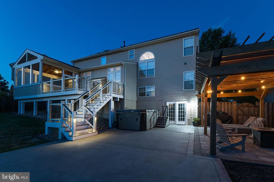 Stunning 5 bedroom 4 bath colonial home in New Town Meadows offering three finished levels with a spacious open concept that is ideal for entertaining and family living!  Two car garage with new door and oversized driveway for additional parking!  Elegant two story foyer, formal living room and dining room with detailed trim.  Spacious family room with built-in shelving and floor-to-ceiling stone gas fireplace. Gorgeous updated kitchen with stainless steel appliances, granite countertops, farmhouse sink, gas cooktop, double ovens, center island and two pantries. Cheerful sunlit eat-in kitchen with additional cabinets. Main level bedroom and a full bath.  Custom deck with integrated automated deck lighting and screened porch that overlooks a beautiful back yard oasis!  Fenced rear yard with a patio, pergola, lush landscaping and trees offering privacy!  Multipurpose recreation area with basketball court, custom built inground trampoline and rubber mulched play area.  Custom built shed with garage door for added storage! New roof in 2022.  Detailed trim on main and upper levels.  The upper level has 4 bedrooms, 2 full baths and a laundry room.  The primary bedroom has a vaulted ceiling, two walk-in closets and a spacious bath with soaking tub and separate shower. The finished walk-out basement has a recreation room with an electric fireplace, barnwood accent wall, full bath and a home theatre room with tiered flooring. Property includes a Vector21 Series V150P is a huge party spa combining the features of a hot tub and swim spa in one space-age vessel. This unique hybrid design has eight massage seats with world-class hydrotherapy, as well as two explosive Whitewater-4 jets in the foot well for powerful leg and foot massage. Equipped with three additional Whitewater-4 jets at the swim end, you will enjoy aquatic fitness with the fully-adjustable flow control. Size 150in.x90in.x50in, gallons:950.  This exceptional property offers everything you need for comfortable and luxurious living in the heart of Lovettsville.  Walk to downtown Lovettsville for groceries, breweries and dining options. Community amenities include neighborhood playground, park and walking paths.  
Listing Agent related to seller.   Theatre chairs and movie projection equipment do not convey.