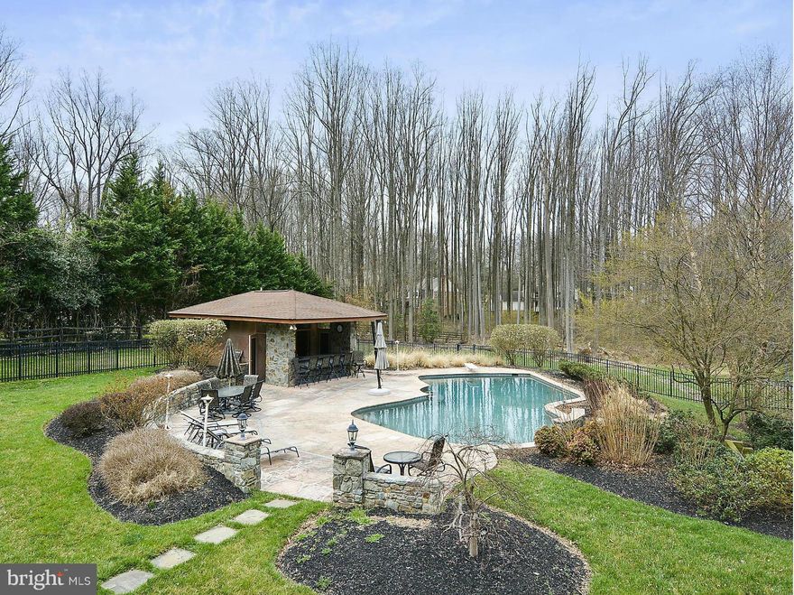 The Pool is Open! Over 1 acre of land sets this house apart. Entertainer's dream; amazing backyard; pool & pool house w/full bath; ironwood deck & irrigation system. 38' addition on 2 levels; renovated gourmet kitchen; new carpet throughout; marble master bath w/steam shower & heated floors. Finished lower level w/full bath, 2 large recreation areas & exercise room. New 50-yr architectural roof. M