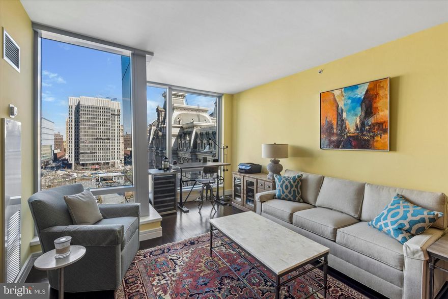 This beautifully upgraded and meticulously maintained home is your sanctuary in the heart of the City. Floor-to-ceiling operable windows fill the space with natural light while framing the city’s iconic City Hall and offer a perfect view of Dilworth Park. 
The gourmet kitchen features sleek European Oak cabinetry, Kashmir white countertops, and premium appliances, including a Viking gas range and convection microwave, Sub-Zero refrigerator, and Miele dishwasher.
The spacious bedroom easily accommodates a king-sized bed and offers custom closet, all while providing stunning views of City Hall. The luxurious ensuite bath is a true spa-like retreat, adorned with Calacatta Gold marble, a double vanity, an oversized glass-enclosed shower, and a Bain ultra-soaking tub for the ultimate relaxation experience. Uniquely for a 1-bedroom home, there is also a guest powder room—a rare and highly desirable feature—along with a laundry closet equipped with a Asko stackable washer and dryer.
The best of luxury living awaits you, with the world-class Ritz-Carlton services and resident-only amenities. These include 24-hour concierge; porters, chauffeur service, a state-of-the-art fitness center, an indoor lap pool, hot tub, and locker rooms with showers, and a private yoga room. The resident lounge is perfect for daily use or private events at no additional cost. Additional amenities include a theater room, a newly renovated outdoor terrace with grills, dining areas, fire pits, and lounge seating, an on-site dog park, and a gated garden with direct access to The Ritz-Carlton Hotel.