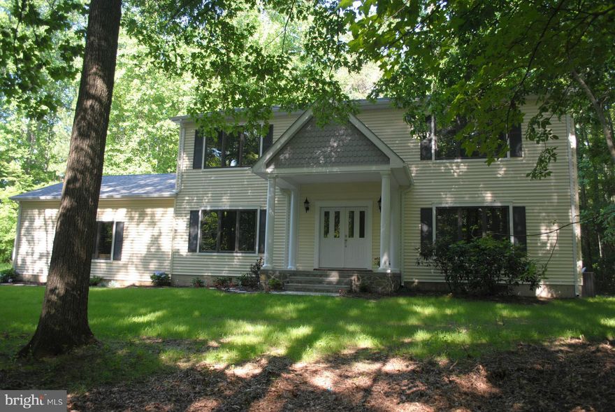 Private 3 acre wooded lot with a stream and plenty of trees for seclusion.  You are close to everything yet tucked way and close to shopping center.  Completely remodeled with an open floor plan, gourmet kitchen with stainless steel appliances and custom cabinets.  Laundry room upstairs and a mud room on main level.  Seller offering closing cost assistance.