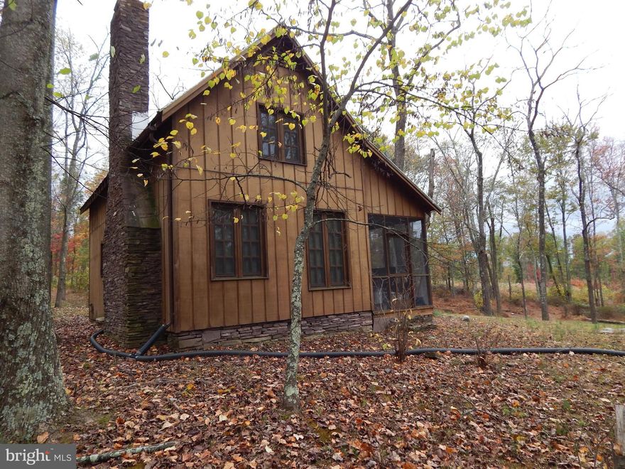 LIVE OFF THE GRID   Cabin w/ screened porch, leading to LR w/ stone FP + a wood stove, kitchen, small BR, & BA  Upper level open for multiple bunk beds & Bath. Well & Septic but no electric.  Gas appliances, gas lighting, need gas generator to operate the well. Featuring 144 acres, backing Sleepy Creek Public Hunting and Fishing Land for added usage of 22,900 acres.