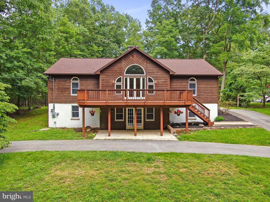 HUGE PRICE REDUCTION!! Enjoy Winter Views of Lake Shannondale from This Beautifully Appointed Home Backing to a Wildlife Preserve! This spacious and inviting retreat seamlessly blends comfort and nature. Nestled against protected woodlands, the home boasts a recently stained deck and a light-filled four-season room—perfect for taking in peaceful, year-round views. The fully equipped kitchen features custom cabinetry, granite countertops, and a stylish tile backsplash, ideal for both entertaining and everyday living. Cozy up by the woodstove on the lower level or gather around the stunning floor-to-ceiling brick fireplace in the main living area. Generously sized bedrooms, a dedicated laundry/pantry space, and a convenient circular driveway add to the home's thoughtful design. Throughout, you'll find a tasteful mix of hardwood, luxury plank, and tile flooring. Whether you're seeking a serene full-time residence or a weekend escape, this exceptional property is a must-see!