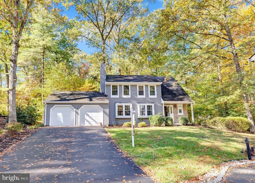 Welcome to this beautifully maintained Colonial in the highly sought-after Woods of Burke Centre. With three finished levels, four bedrooms, two full baths and two half baths, this home blends modern updates with everyday comfort. The renovated kitchen features black soapstone countertops, custom cabinetry, and limestone flooring that opens seamlessly to the dining and family areas, highlighted by hardwood floors and a stone fireplace. Upstairs offers four spacious bedrooms and two remodeled baths, including a primary suite with an extensive custom closet, bonus storage through the primary bath, and additional storage above the garage. The finished lower level adds flexible living space for a rec room, home gym, or office. Outside, enjoy a landscaped yard on a private pipestem lot backing to wooded walking paths, with nearby tot lots—one directly adjacent to the home—and access to five community pools available through a pool membership. Dining, shopping and the VRE are only minutes away! This well-cared-for home offers the perfect mix of comfort, convenience, and community in the heart of Burke Centre.