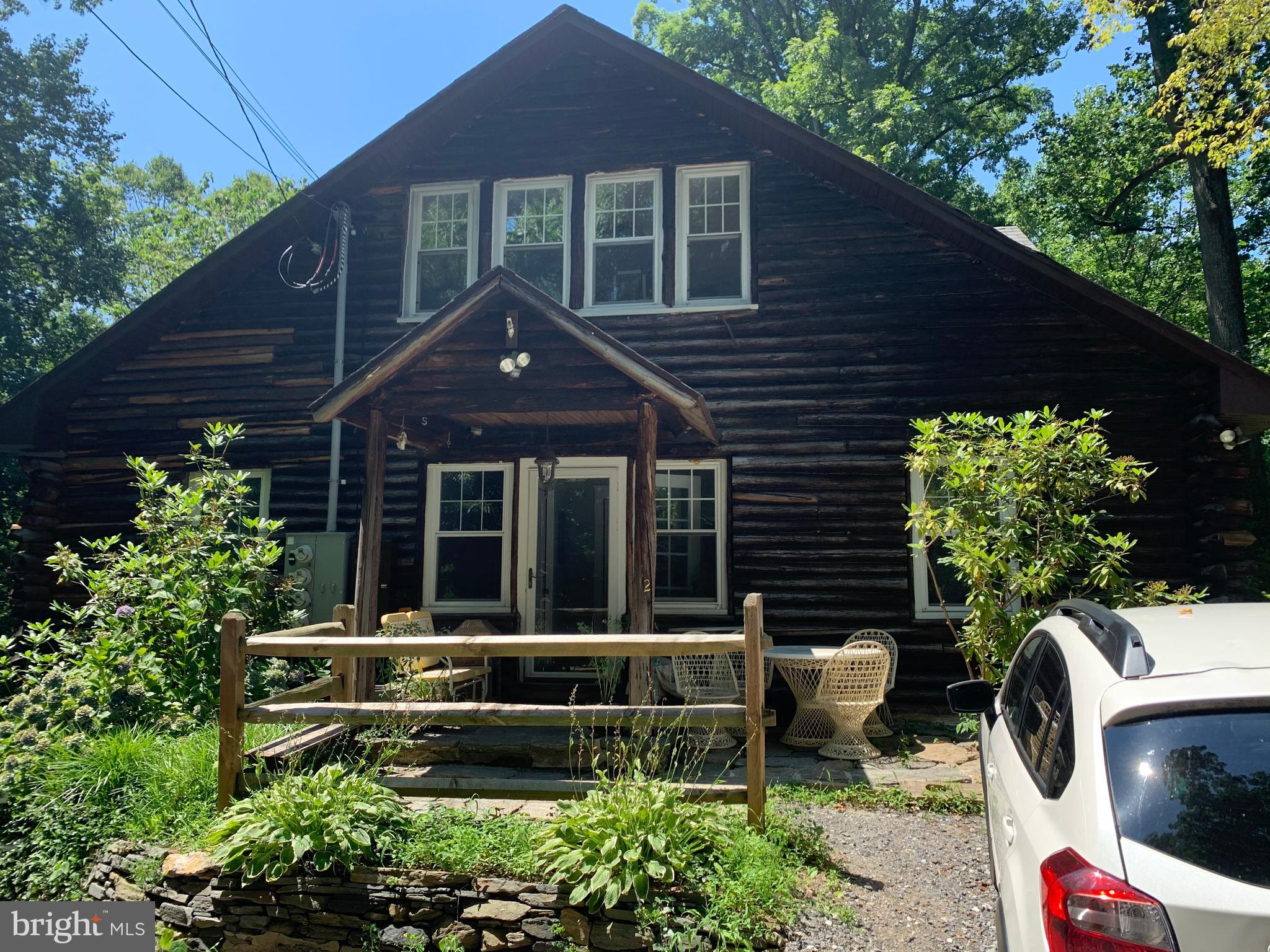 This first floor apartment in a Log Home has been completely renovated. The location in the heart of lovely Rose Valley borough is "to die for" with beautiful views of the woods and stream, walking paths, and at the end of a quiet cul de sac street. New kitchen with granite counter tops, stainless appliances and stack-able laundry, Living/Dining room with wood burning fireplace, 3 bedrooms, 2 full baths, 2 enclosed porches which could be used as office space, craft room, or additional sitting rooms. The views are fabulous! Hardwood floors throughout! A very serene neighborhood. Walk to the train station and just a 10 minute drive to downtown Media. Unfortunately, the photos do not do it justice so please set up an appointment to see it!