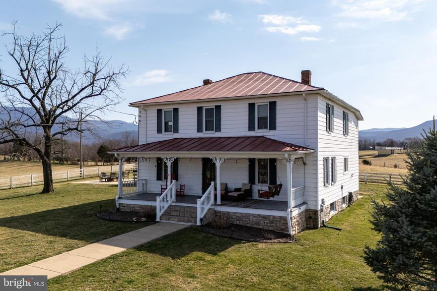 Modernized Farmhouse @ Scenic View Estates! This 4 BR 3 BA  farmhouse blends historical charm with modern upgrades while being situated on 4.7 open acres!  Upon entering the home, you are greeted with a large center foyer that extends the length of the home with a grand staircase . Each room is large and spacious, perfect for luxurious living. There is a beautiful gourmet kitchen with pantry, formal dining room, living room, office and family room. The primary bedroom boasts a private bath and walk-in-closet. The additional bedrooms are large and enjoy the use of a bathroom splashed with natural light! The acreage features a tranquil pond and expansive panoramic views of both the Blue Ridge and Massanutten Mountains! There is a large covered front porch and large rear patio complete with an outdoor fireplace. Both are perfect for outdoor entertaining!  Let's not forget the 3 bay detached garage great for storing cars or equipment! This property is the perfect blend of history, luxury and modern conveniences!