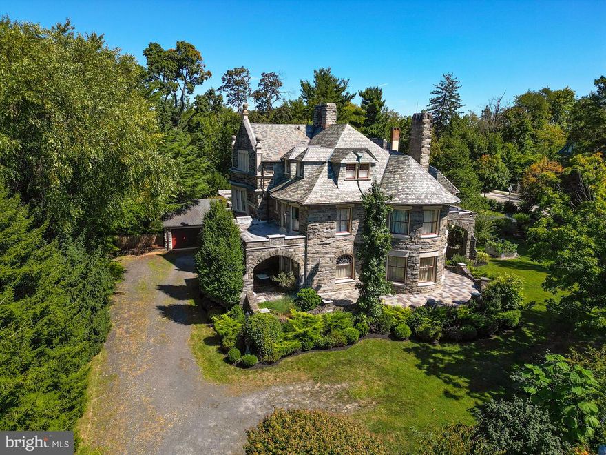 Welcome to St. Martins, an exceptional residence that blends historic charm with modern comforts, offering an elegant lifestyle without the extensive grounds maintenance of a sizeable single-family estate. Nestled on a picturesque .40-acre lot in Chestnut Hill, this architectural gem was designed by Hazelhurst & Huckel and built in 1890 by William Steele. Lovingly maintained and thoughtfully updated over the years, this home preserves its original Richardsonian Romanesque style, crafted from local Wissahickon schist, and is adorned with striking features such as graceful curves, battlements, clipped gables, and a corner turret. Spanning 6,600+ square feet, St. Martins offers superb entertainment flow and exquisite outdoor spaces, including a beautifully landscaped patio with ample room for relaxation and gatherings. The home's interiors are equally captivating, featuring quarter-sawn oak walls and intricate millwork that remain unpainted, alongside restored hardwood floors, all meticulously preserved. The home boasts six unique fireplaces, leaded and stained glass windows, cove ceilings, and detailed plaster moldings, all in pristine condition. On the main level, you'll find spacious formal living and dining rooms with original wall sconces, a well-appointed kitchen with generous storage, granite countertops, high-quality appliances, a powder room, and an extensive office/library. The second floor offers a luxurious primary suite with a dressing room, two additional bedrooms, a second bath, and a convenient laundry room. Once a separate apartment, the third floor features four bedrooms, a remodeled bathroom that honors the home's original aesthetic, and in-wall storage. Enjoy proximity to Chestnut Hill's vibrant shops, restaurants, schools, and cultural institutions, as well as easy access to Center City, major highways, and regional rail. Springside Chestnut Hill Academy, the Philadelphia Cricket Club, and the Chestnut Hill West train station are just steps away, making commuting to your favorite destinations effortless. Listed as "Significant" in the Chestnut Hill Historic District Inventory and featured on the 1895 Bromley Philadelphia Atlas, St. Martins is a rare offering. The home’s light-filled rooms, large rounded windows, and unique architectural elements add charm. This home seamlessly blends historic grandeur with modern conveniences—ready to welcome its next steward.
ᐧ